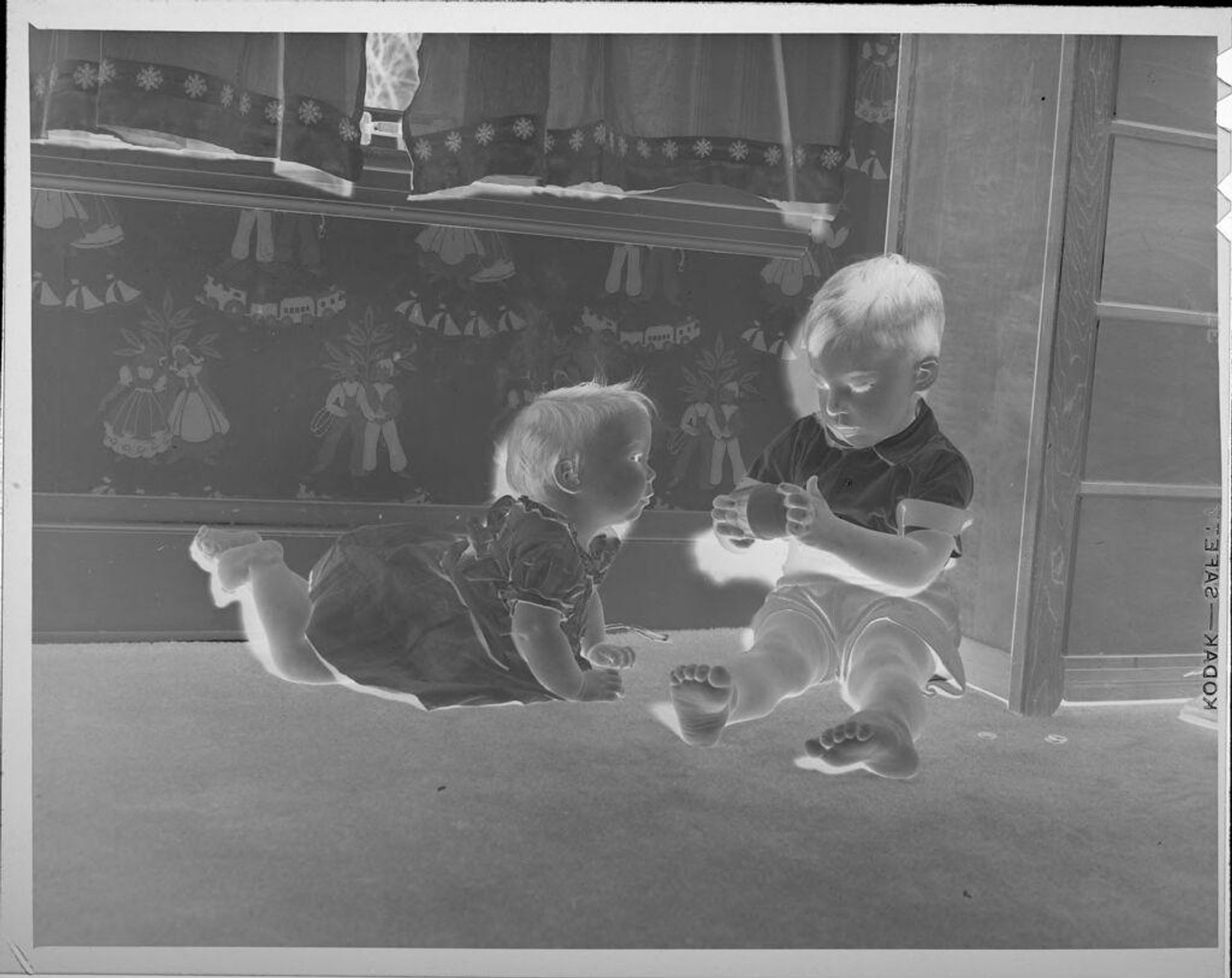 Untitled (two children playing on floor) by Lucian and Mary Brown