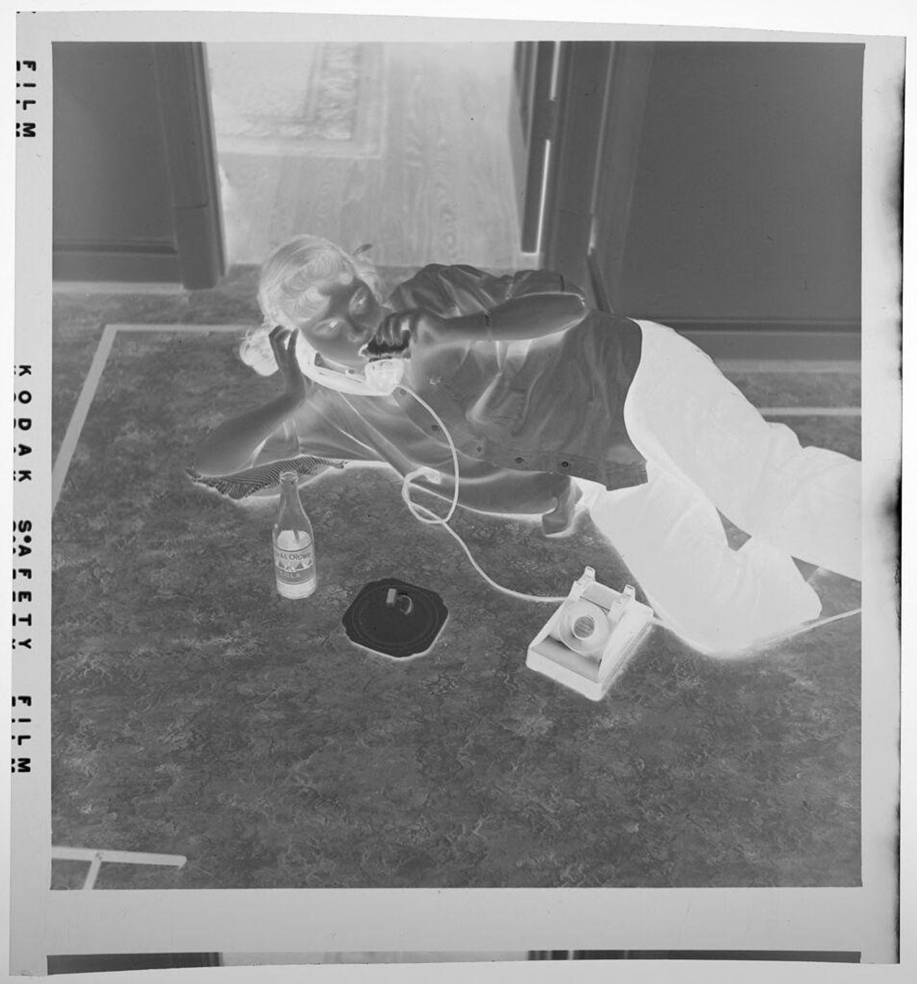 Untitled (girl lying on floor talking on telephone) by Jack Gould