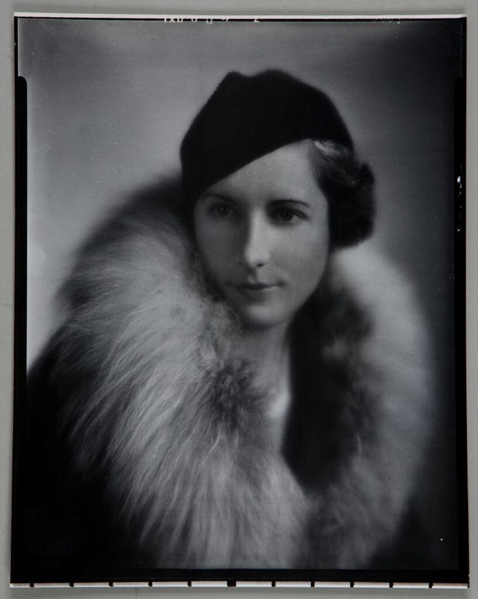 Untitled (bust length portrait of woman in hat and fur lined coat) by Paul Gittings
