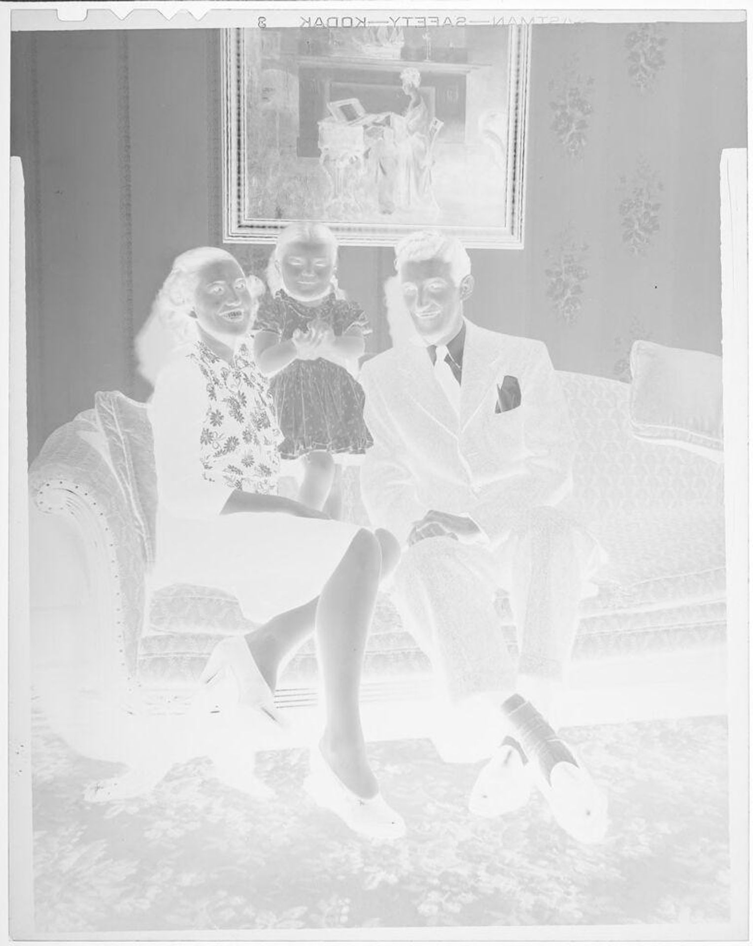 Untitled (parents and daughter on couch) by John Deusing