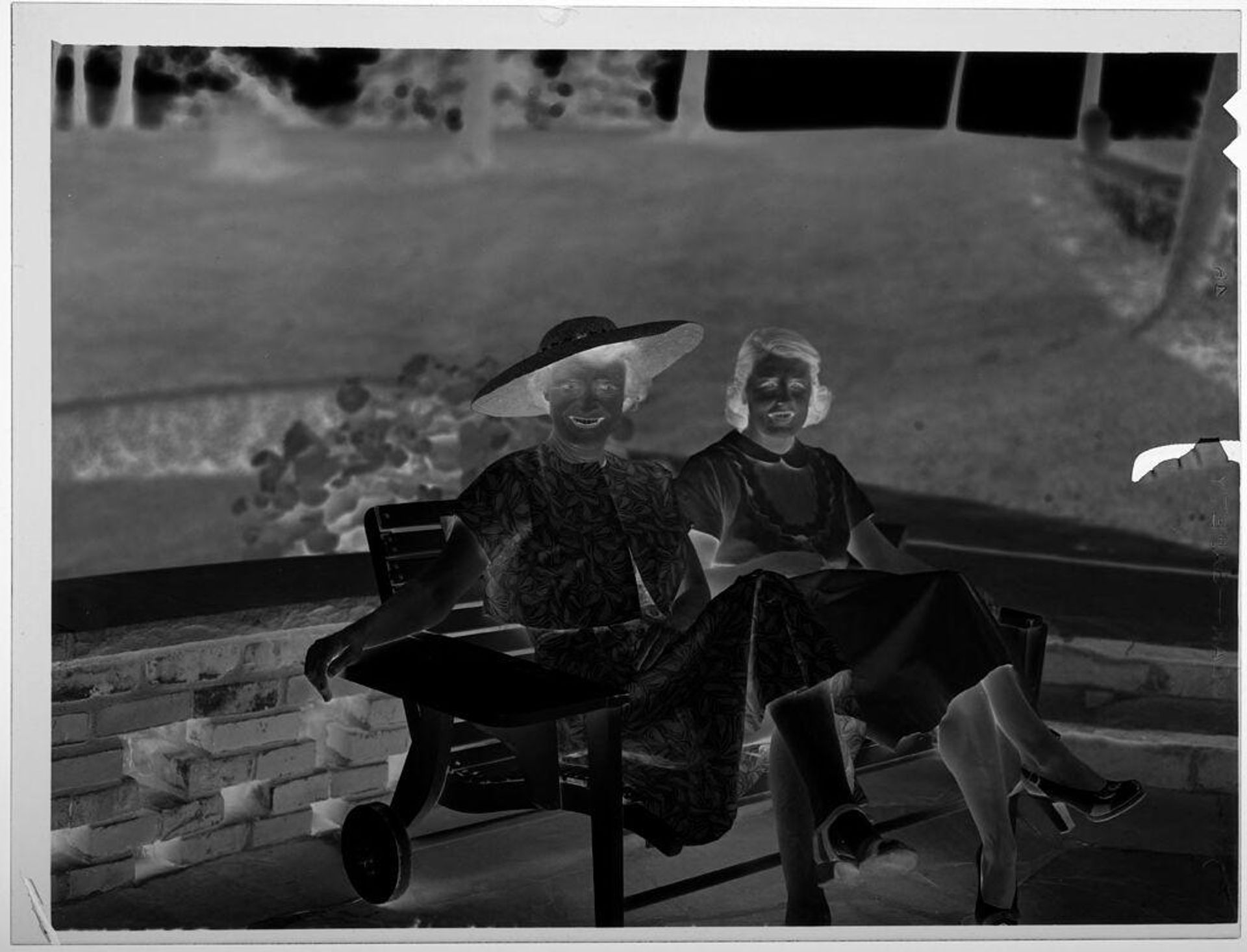 Untitled (two women on park bench, one in a hat) by Jack Gould