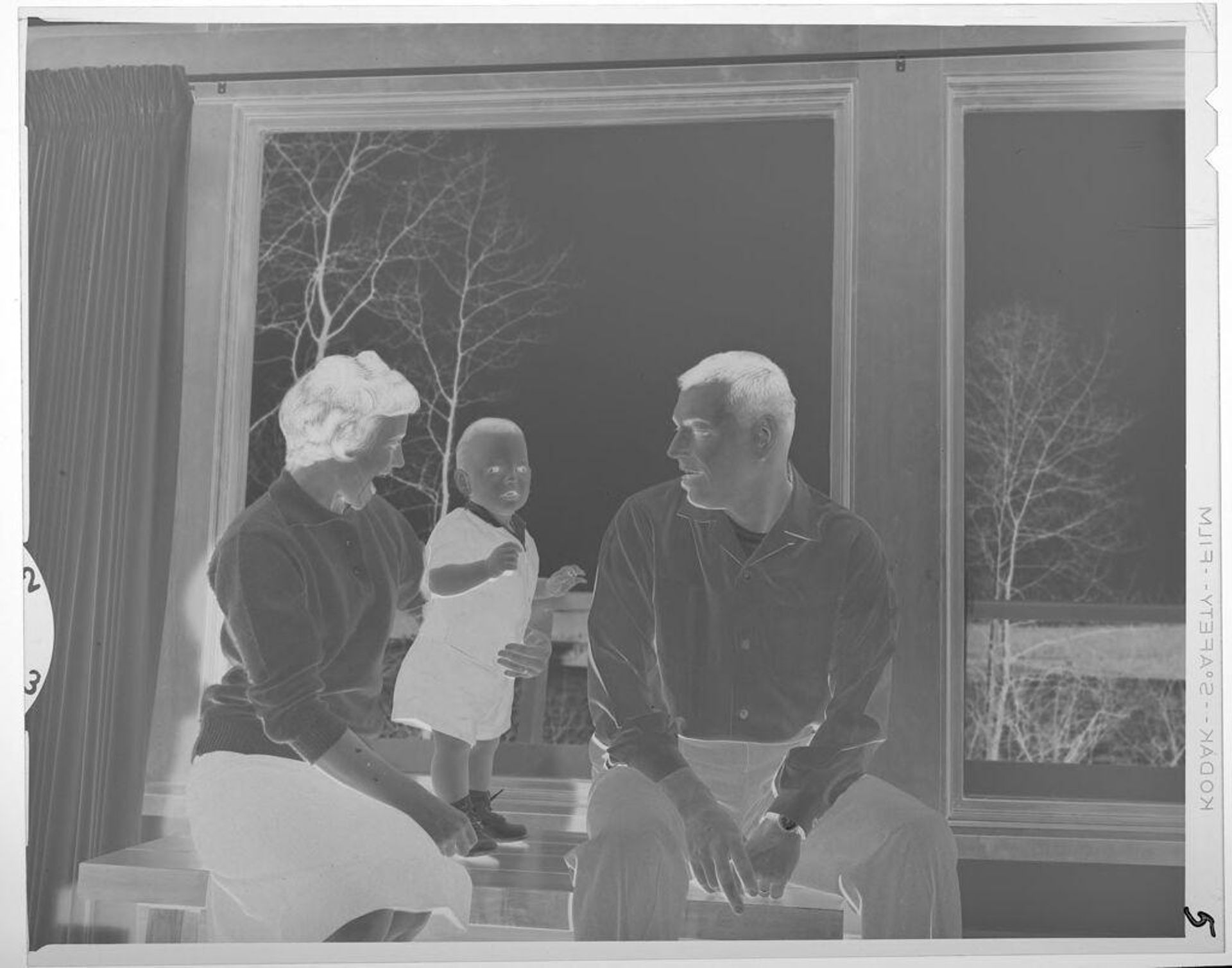 Untitled (man, woman, and baby by window) by Lucian and Mary Brown