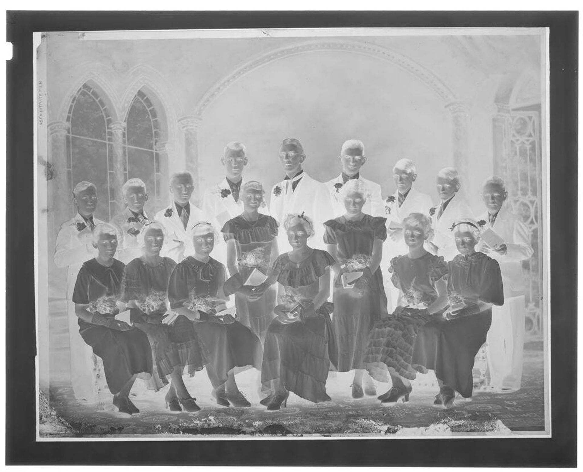 Untitled (group of kids in suits and dresses seated for portrait) by John Deusing