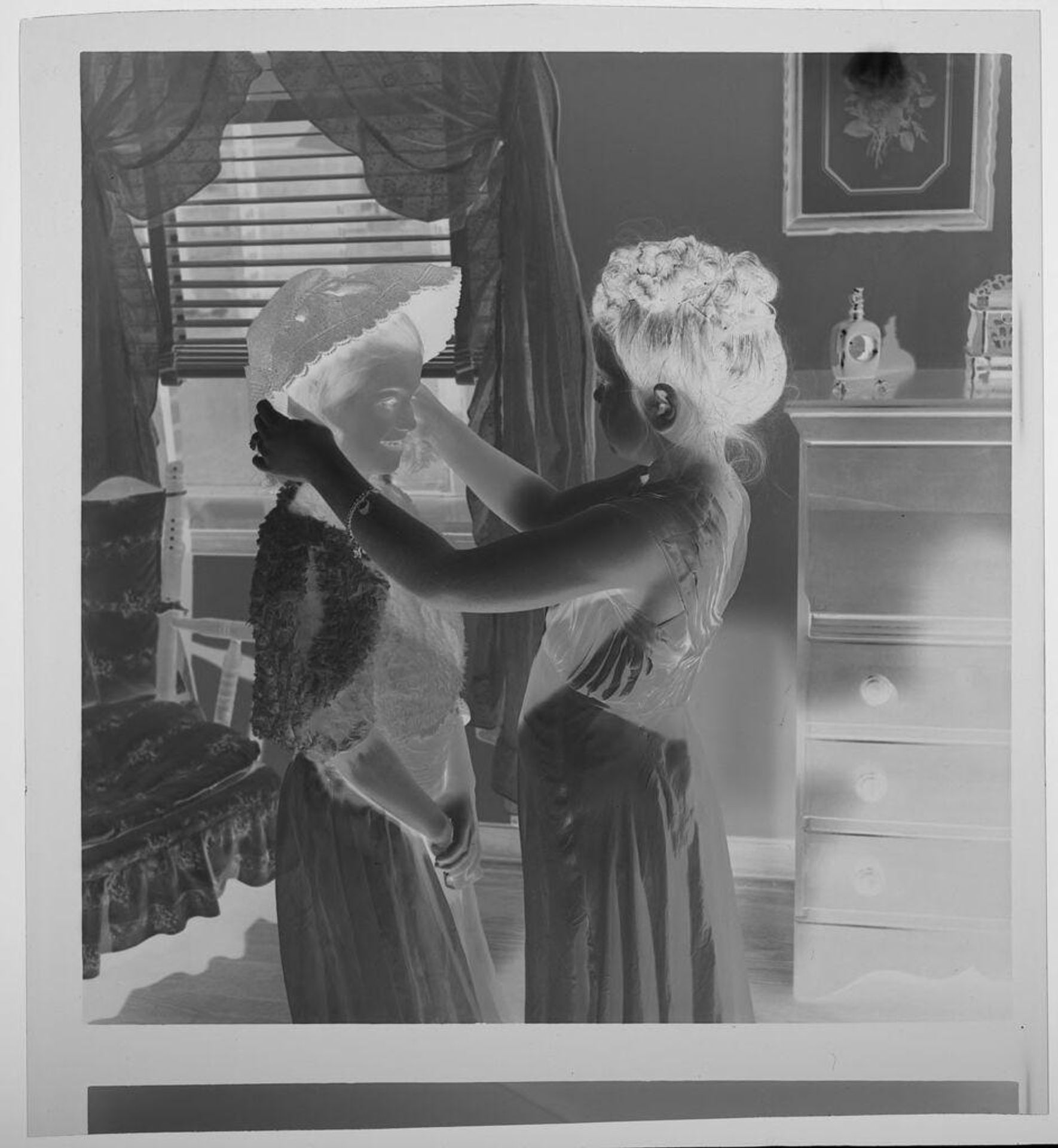 Untitled (two girls playing dress-up, one trying on a hat) by Jack Gould