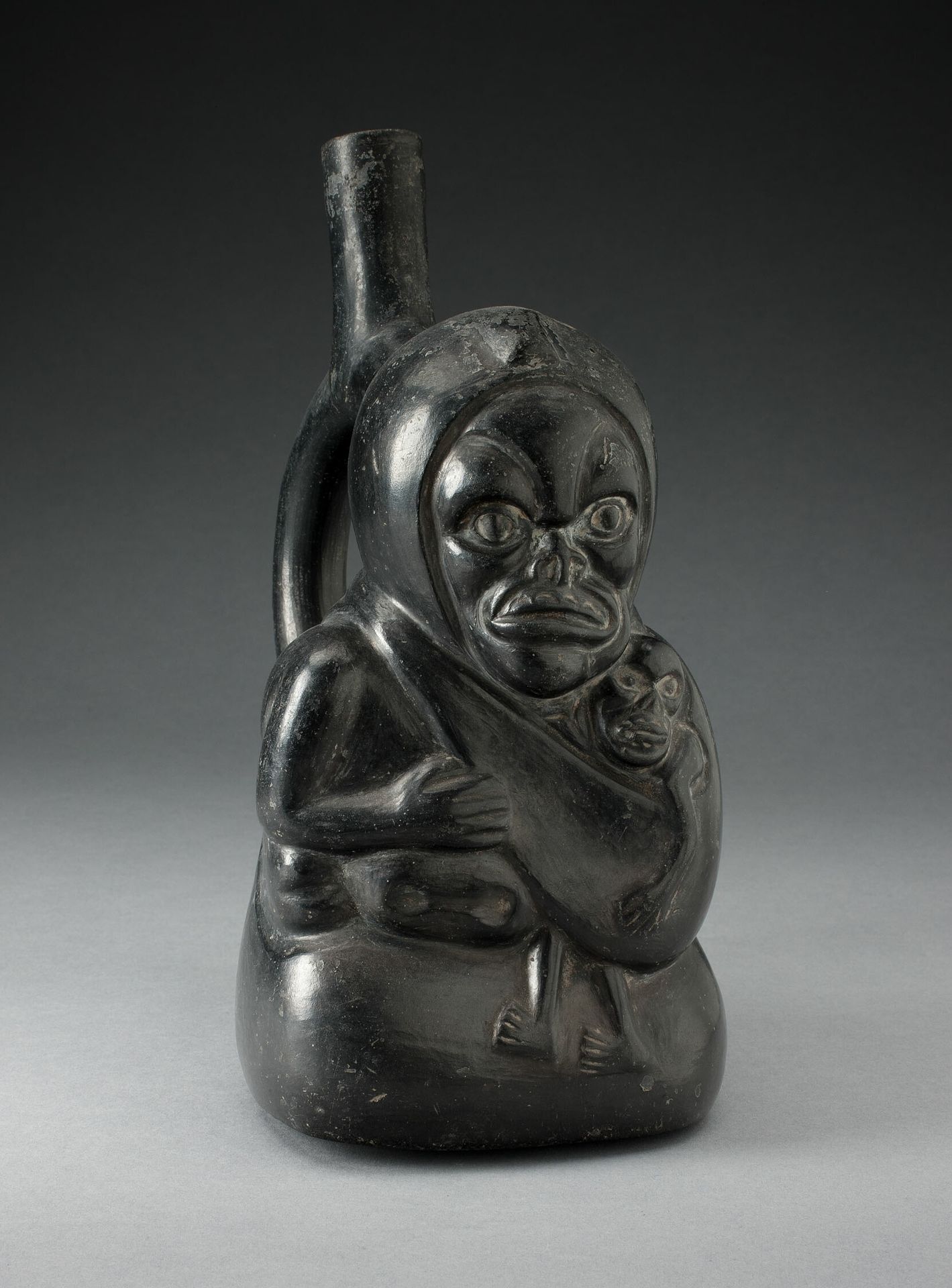Handle Spout Vessel in the Form of a Skeletal Figure Holding a Child by Moche