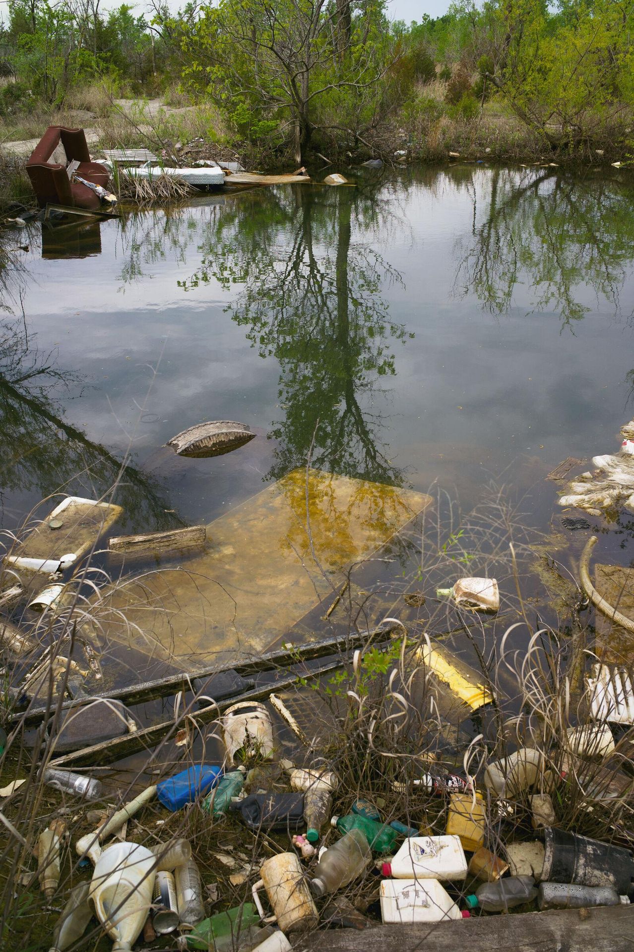 Mine shaft on northside of Treece (Kansas) filled with water and garbage by Alex Webb