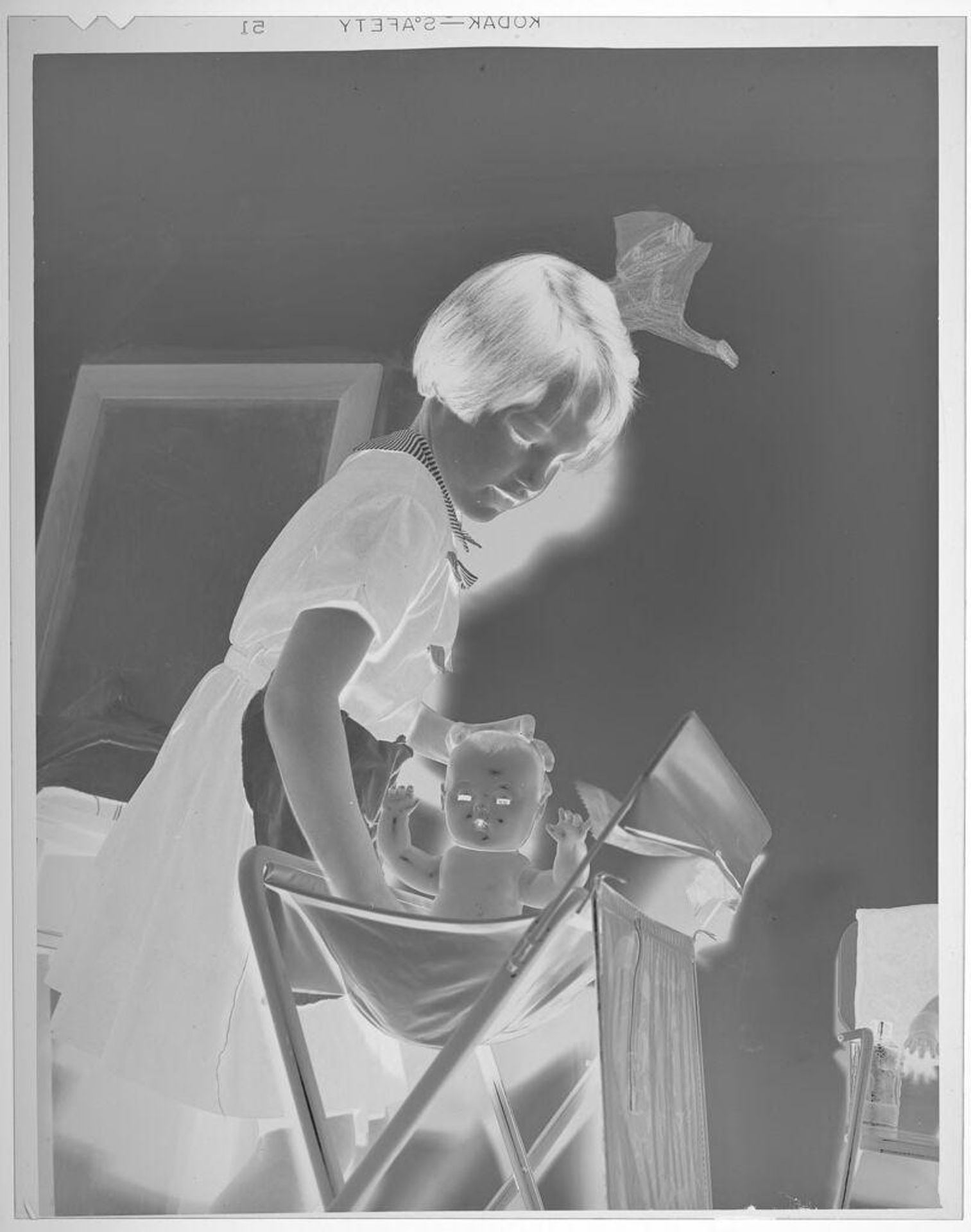 Untitled (little girl playing with doll) by Lucian and Mary Brown