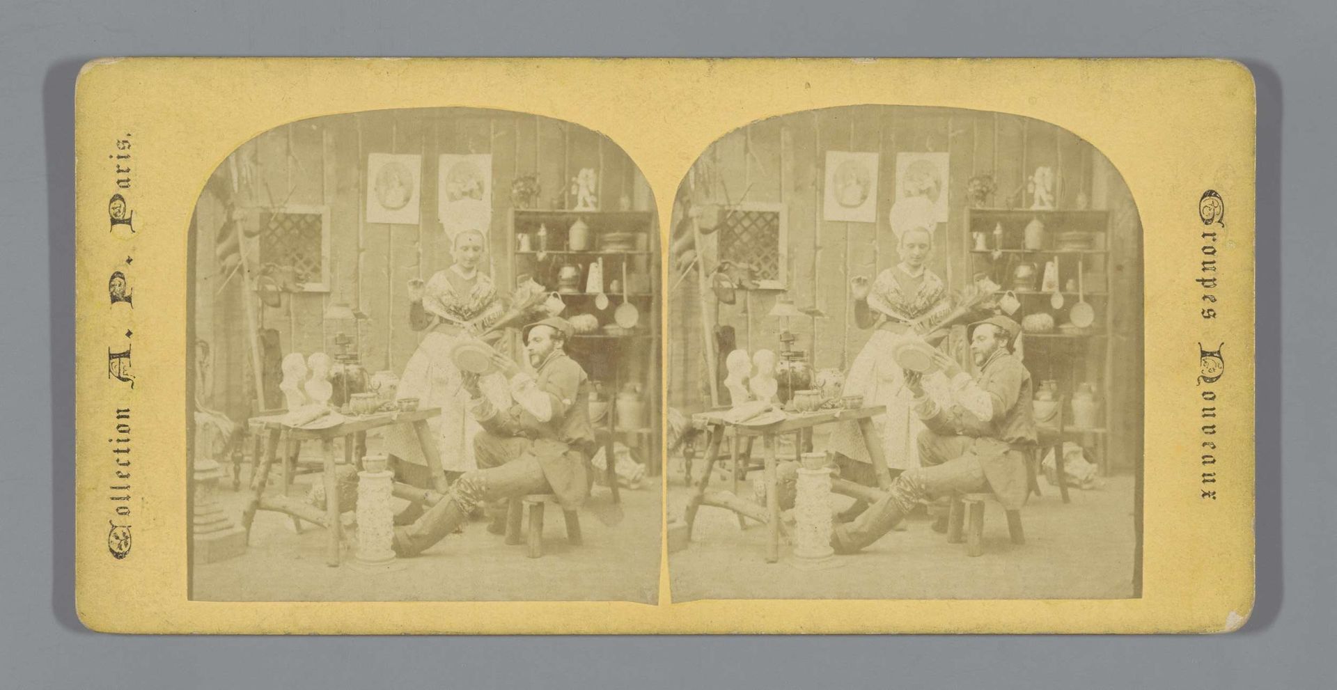 Keramist in atelier met  jonge vrouw in klederdracht by Anatole Pougnet