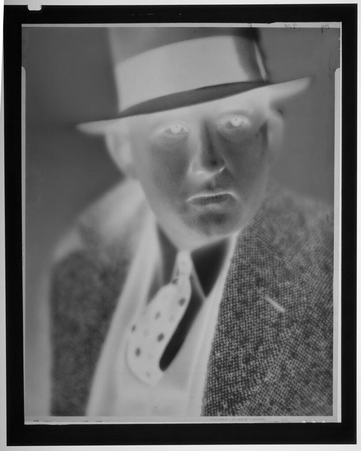 Untitled (close up portrait of man in fedora and wool suit) by Paul Gittings