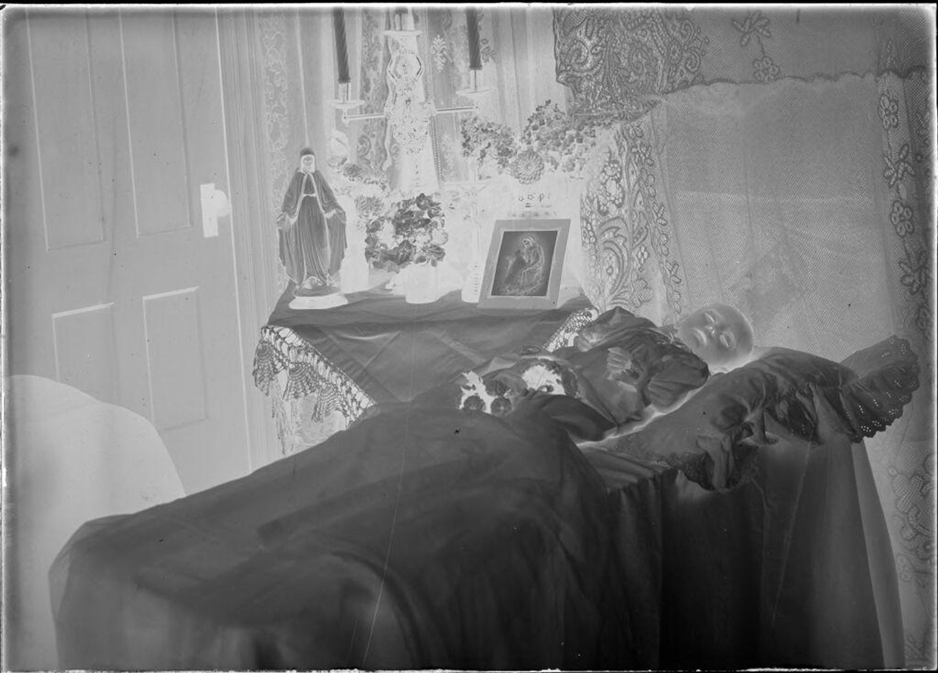Untitled (dead baby, religious statue and image) by Durette Studio