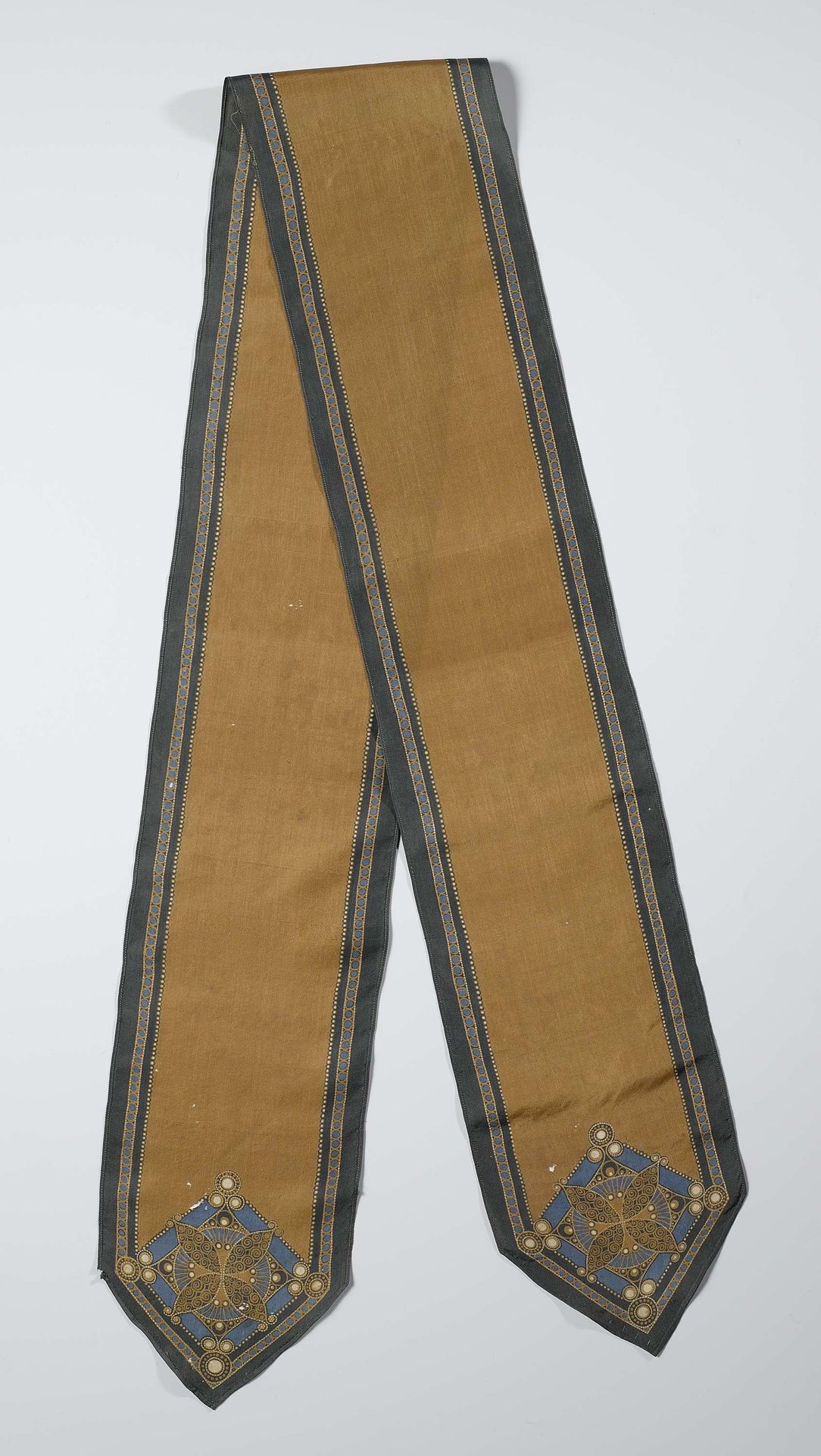 Langwerpige gebatikte sjaal in bruin, groen, zwart, blauw en wit, met onversierd bruin middeldeel binnen een groene rand, stermotief in de twee puntige uiteinden by Chris Lebeau