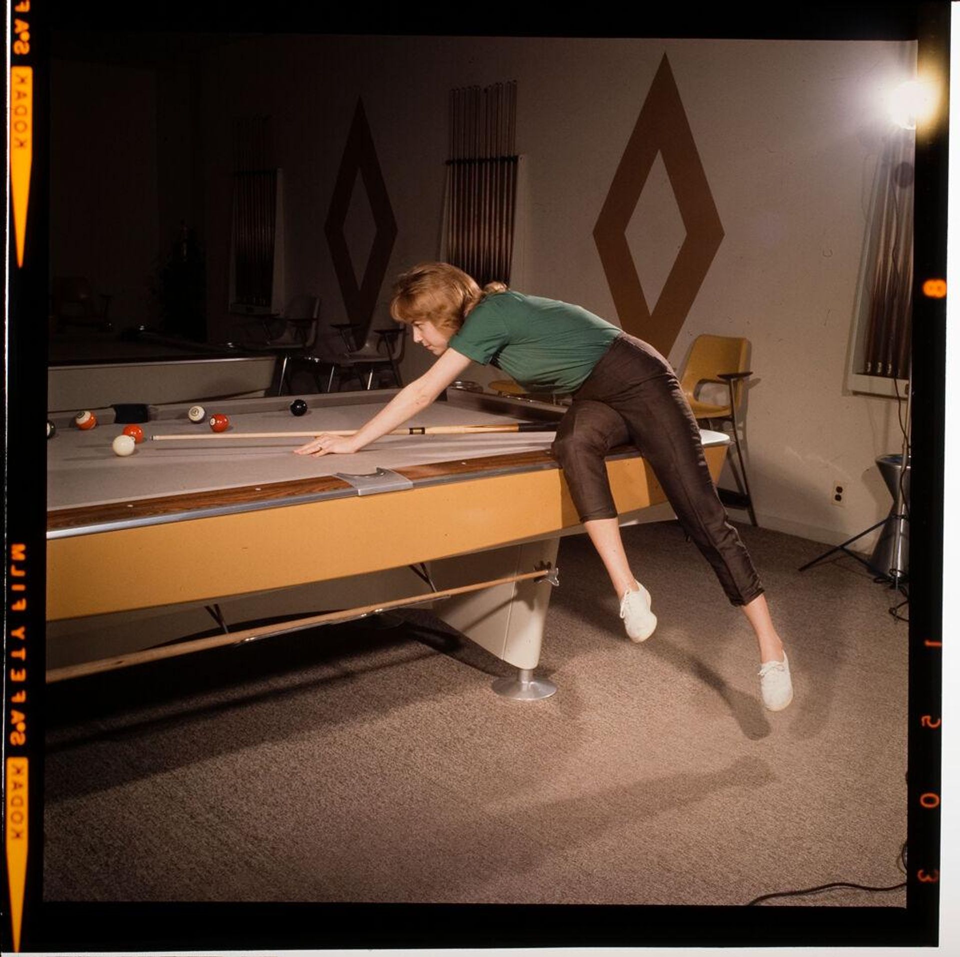 Untitled (woman and child playing pool) by Jack Gould