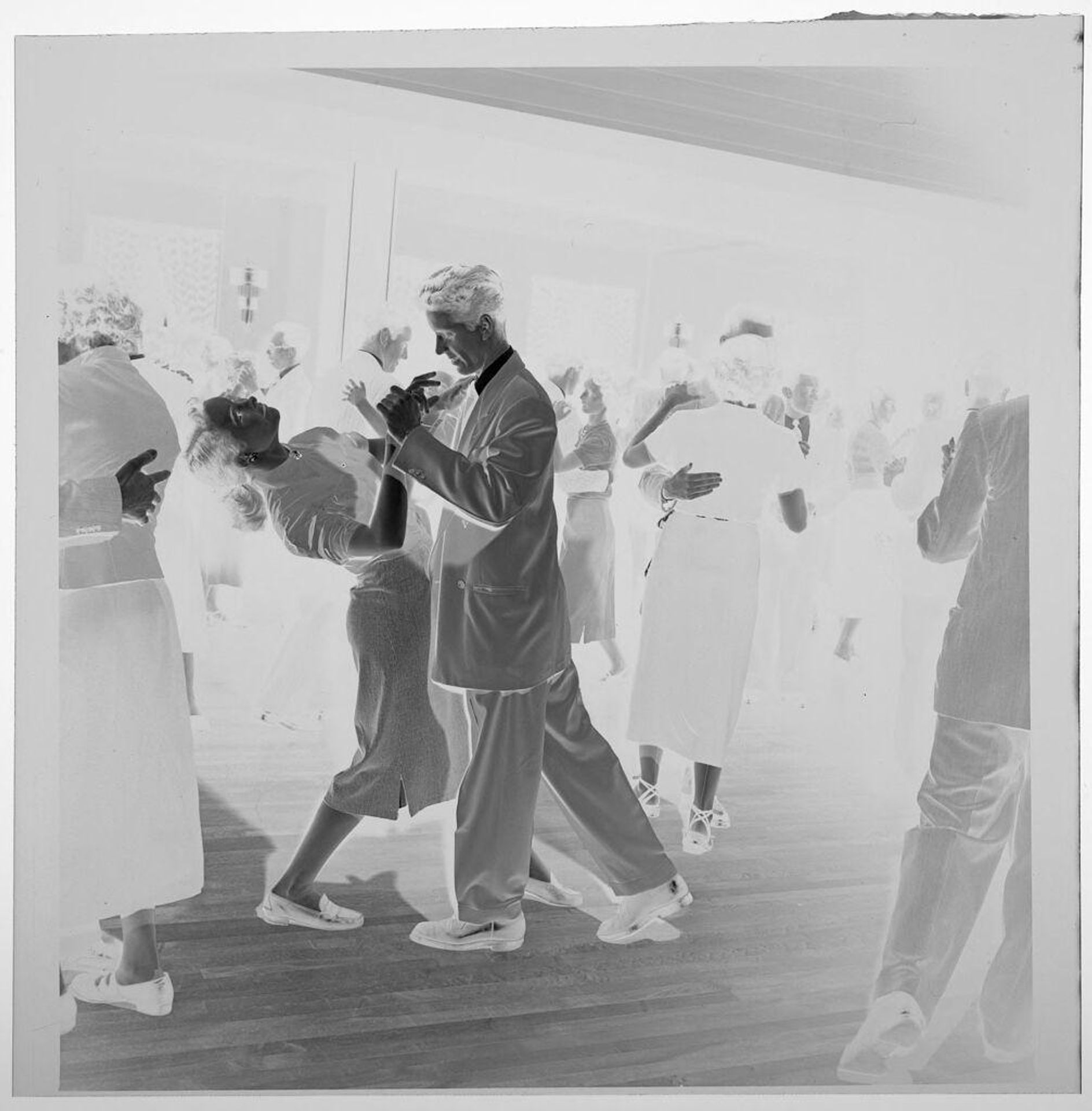 Untitled (couple dancing in large group of people, woman being dipped by partner) by Jack Gould