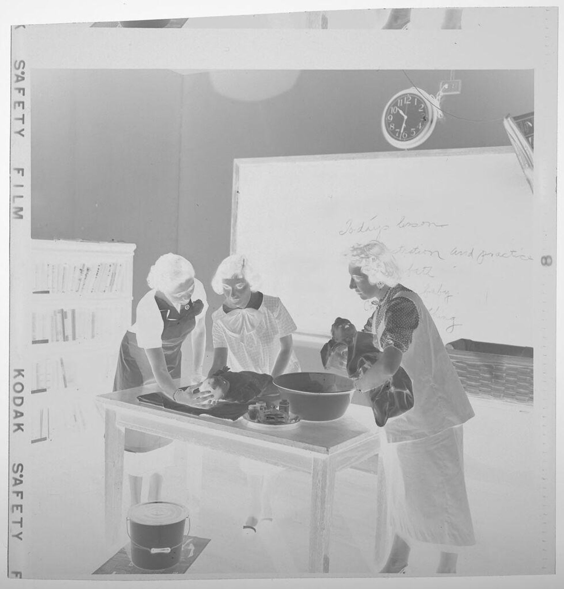 Untitled (three women practicing first aid on fake babies) by Jack Gould