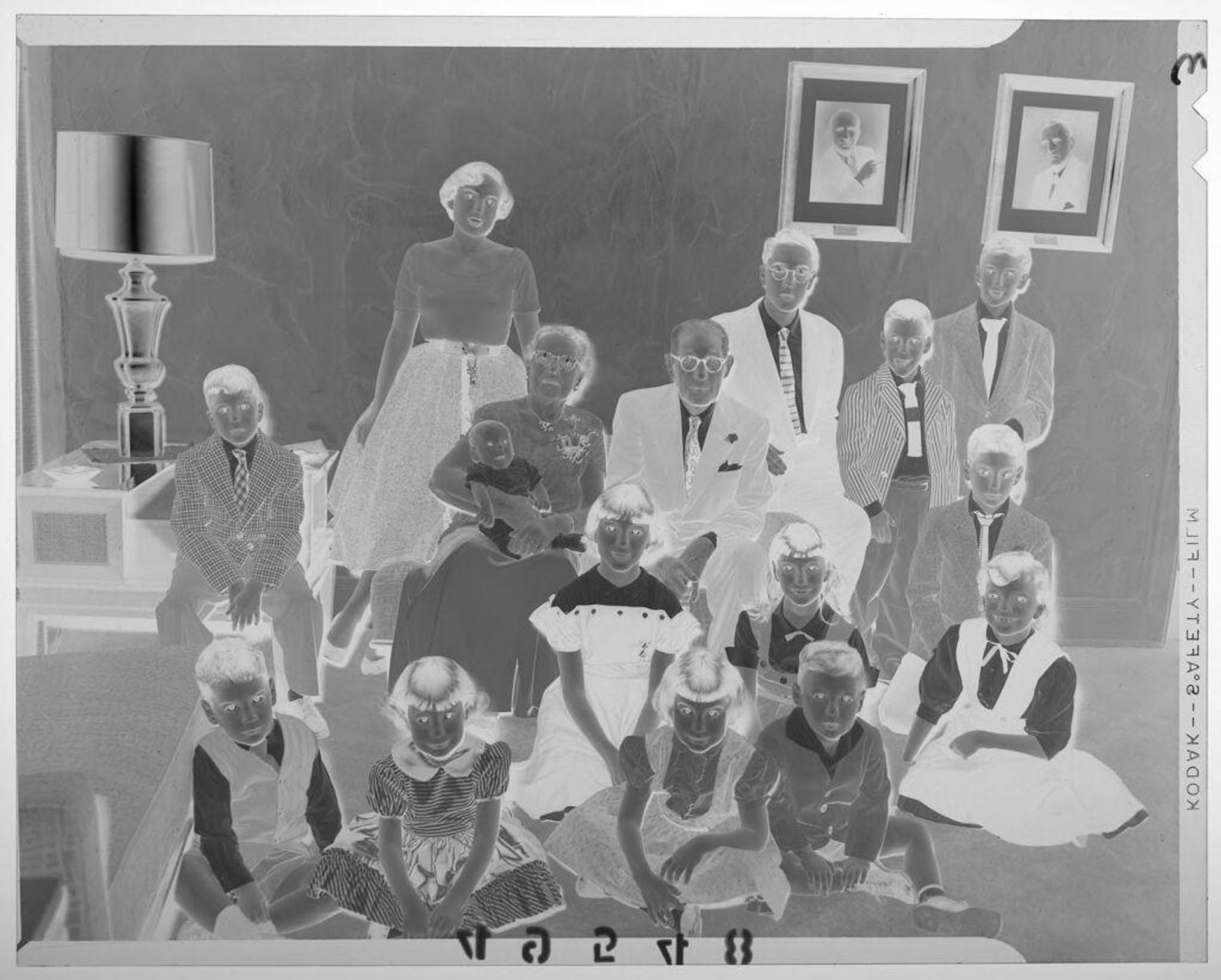 Untitled (old couple posed with large number of grandchildren in living room) by Martin Schweig
