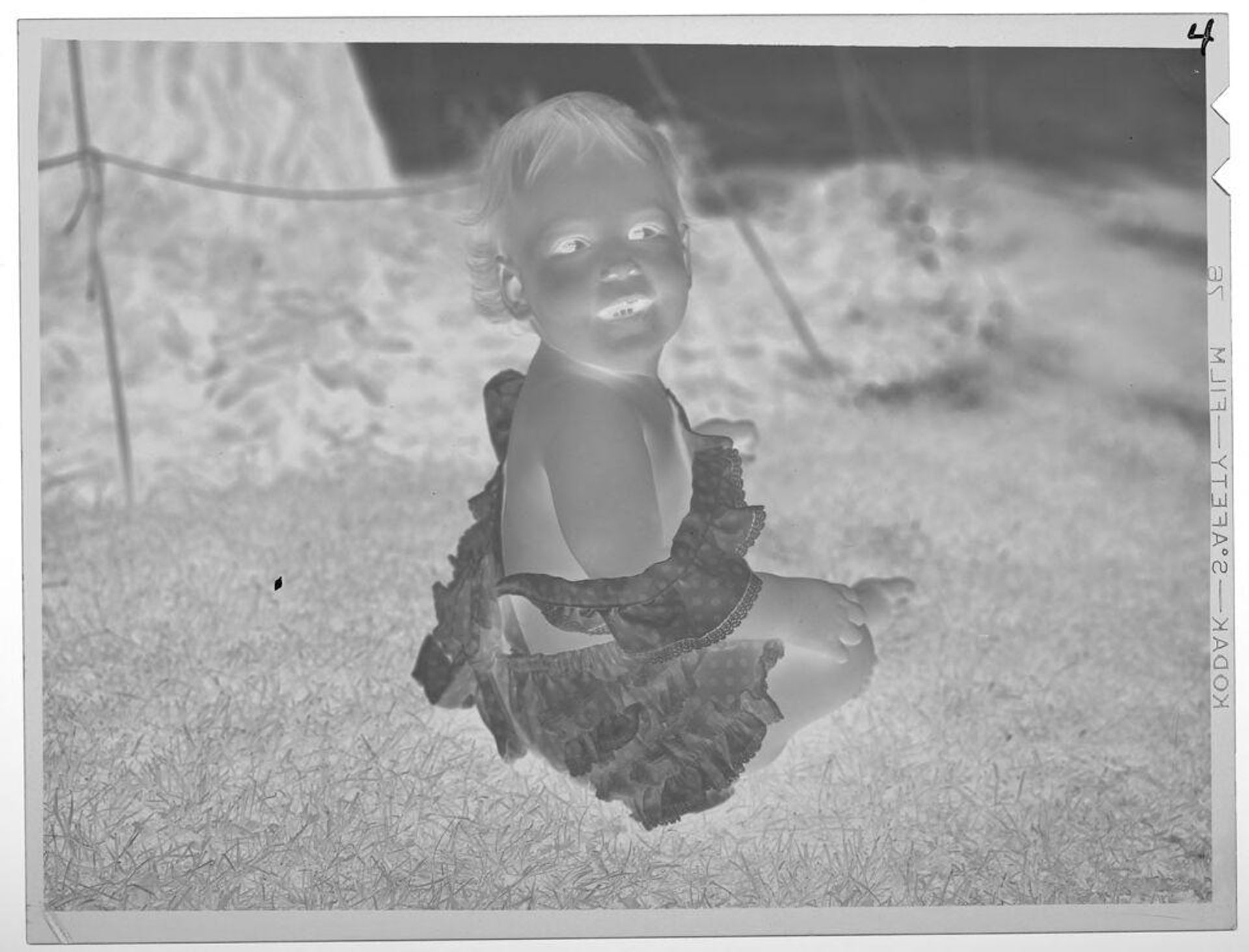 Untitled (baby sitting on grass) by Lucian and Mary Brown
