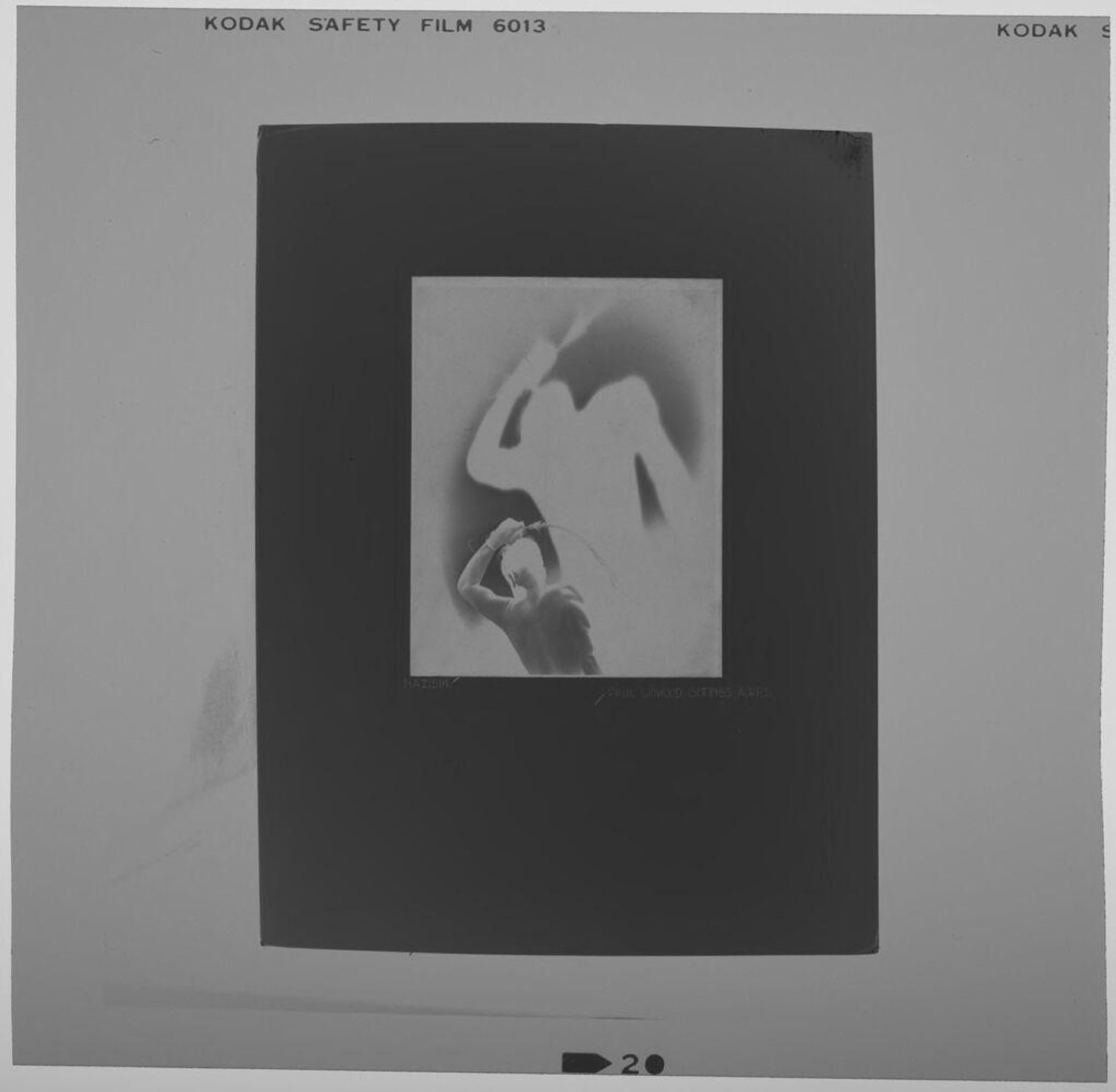 Untitled (photograph of "Nazism": shirtless man with looming shadow) by Paul Gittings