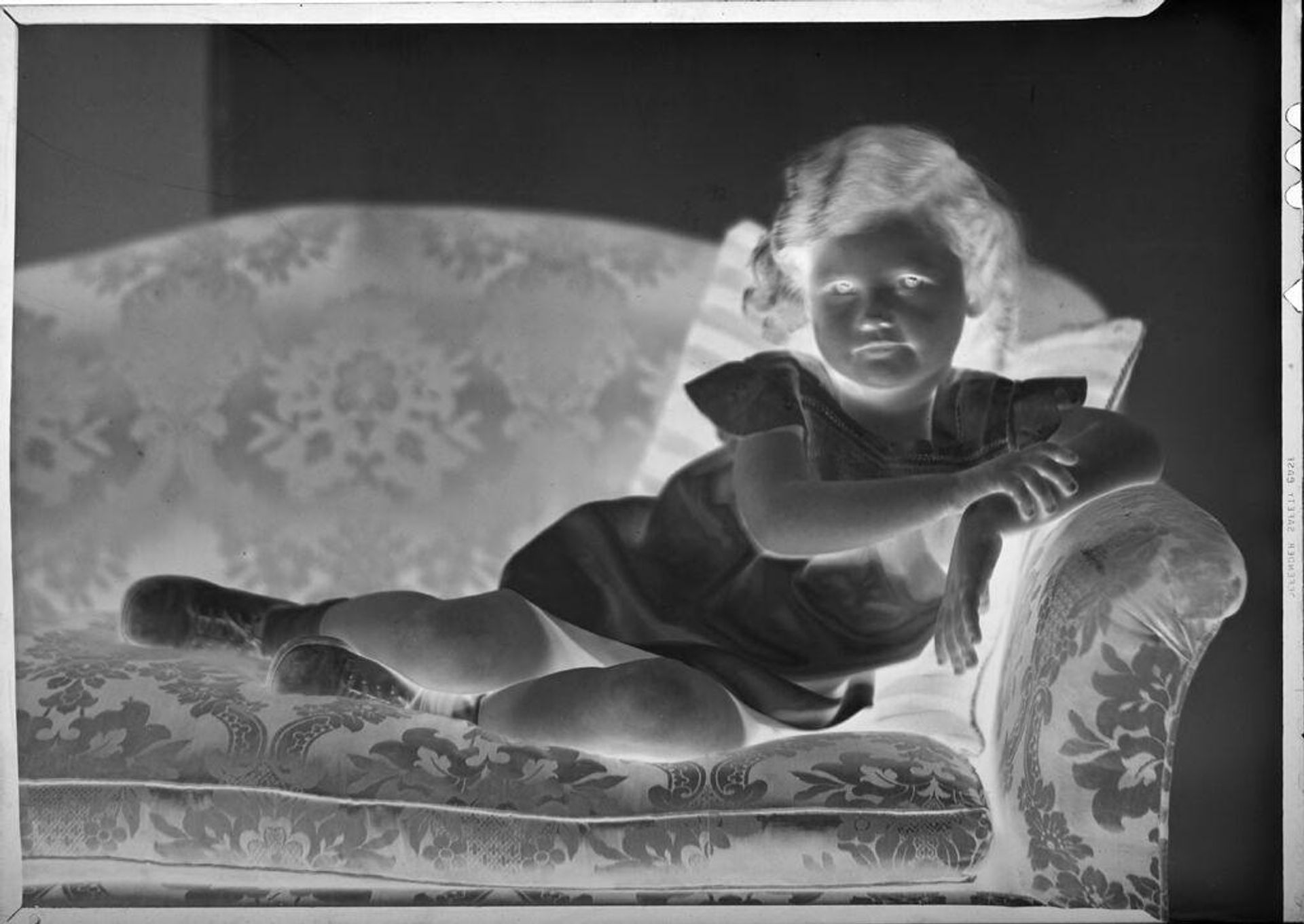 Untitled (little girl on couch) by C. Bennette Moore
