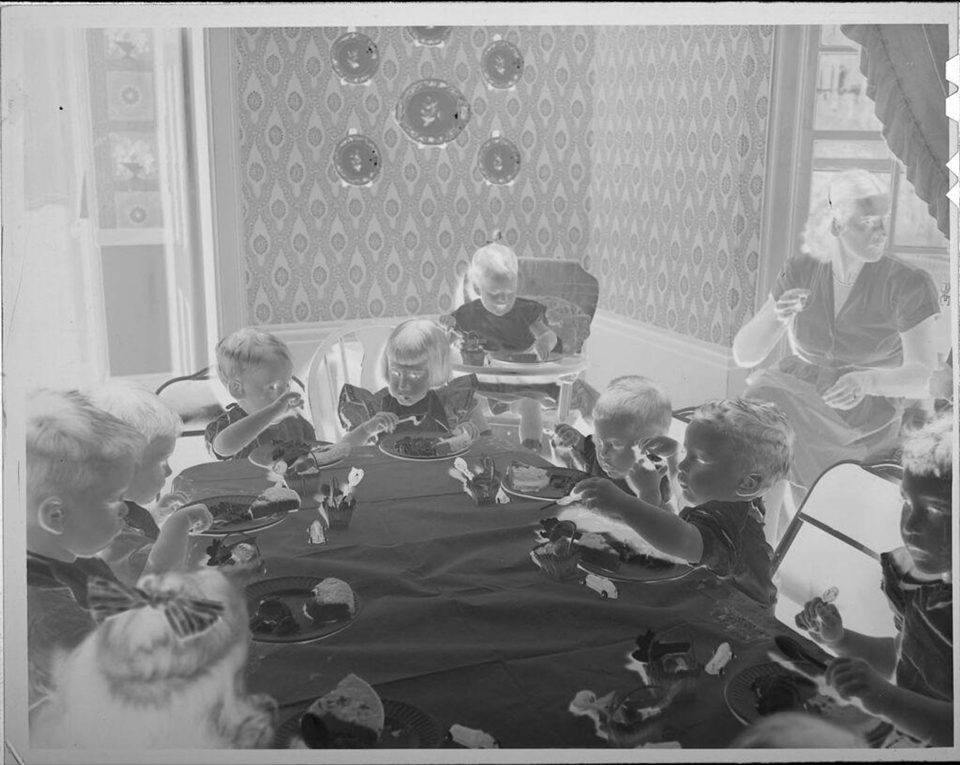 Untitled (birthday party, children eating at table) by Lucian and Mary Brown
