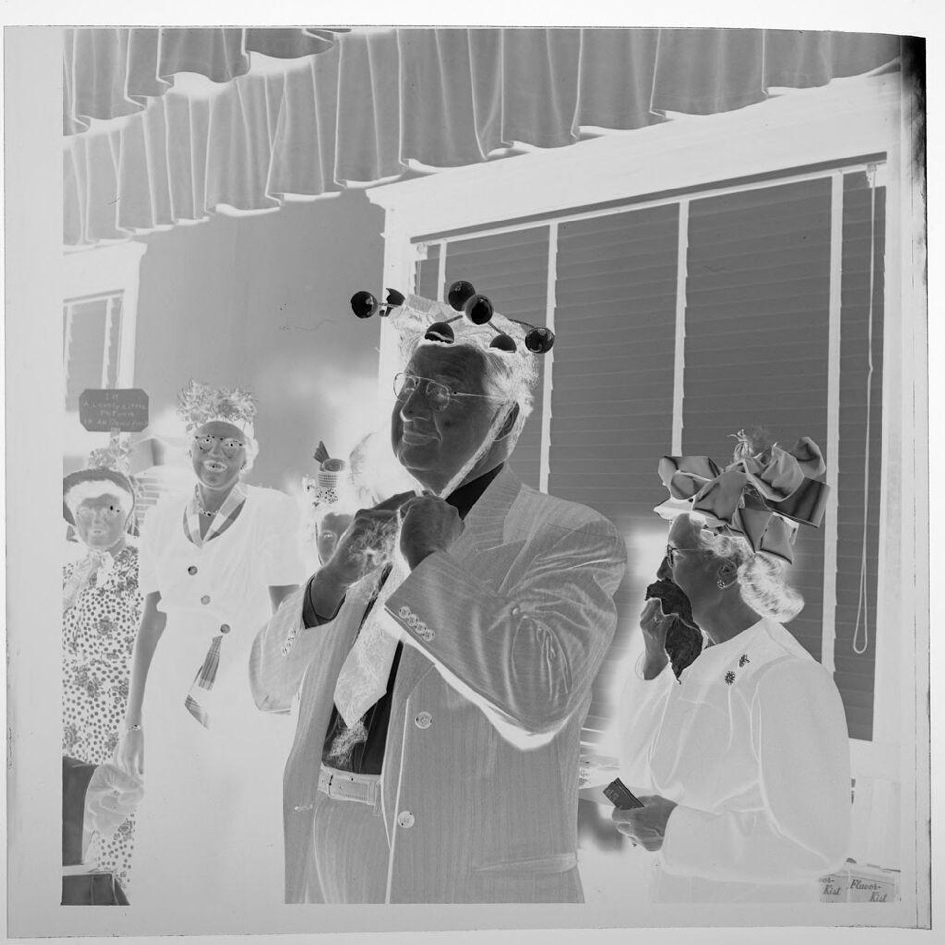 Untitled (people wearing funny hats, man in front) by Jack Gould