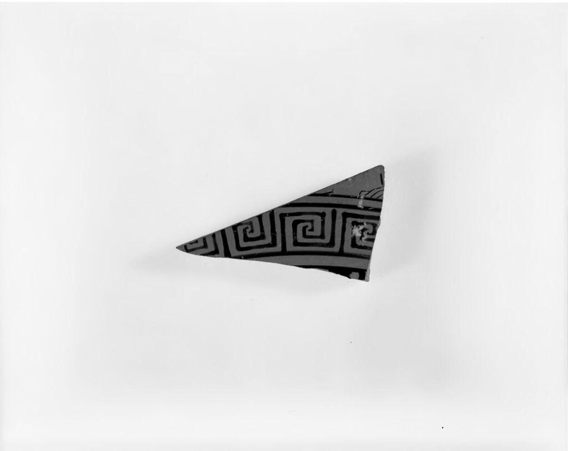 Red-figure cup fragment.  Int., touch of border.  Side A: feet of one to left, maeanders stopt to right. by The Euaion Painter