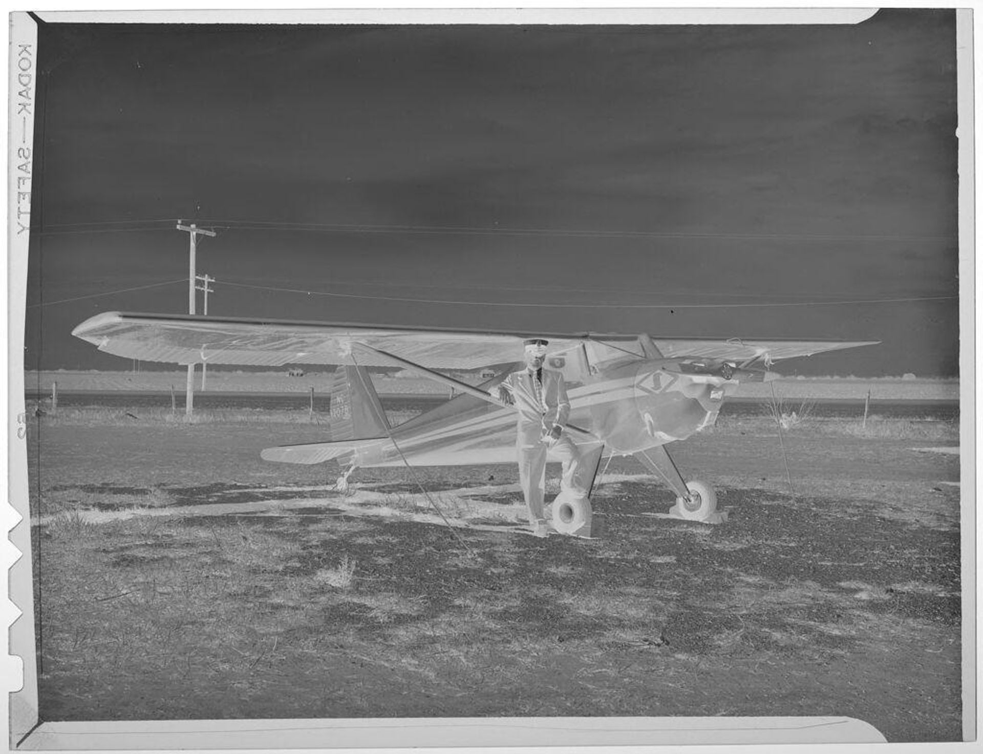 Untitled (pilot, Louis Suffert, standing with plane) by Harry Annas