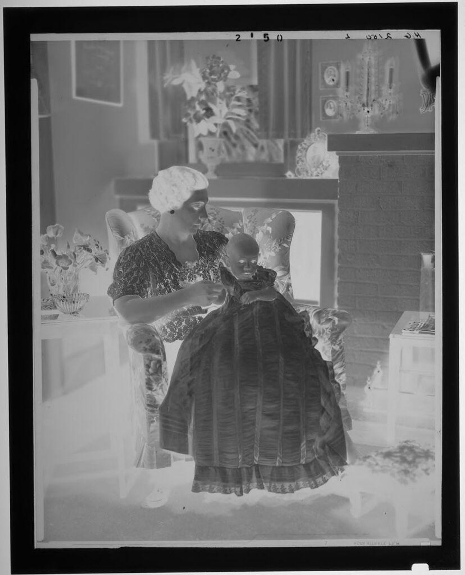 Untitled (woman seated in armchair with baby in long dress on lap) by Paul Gittings