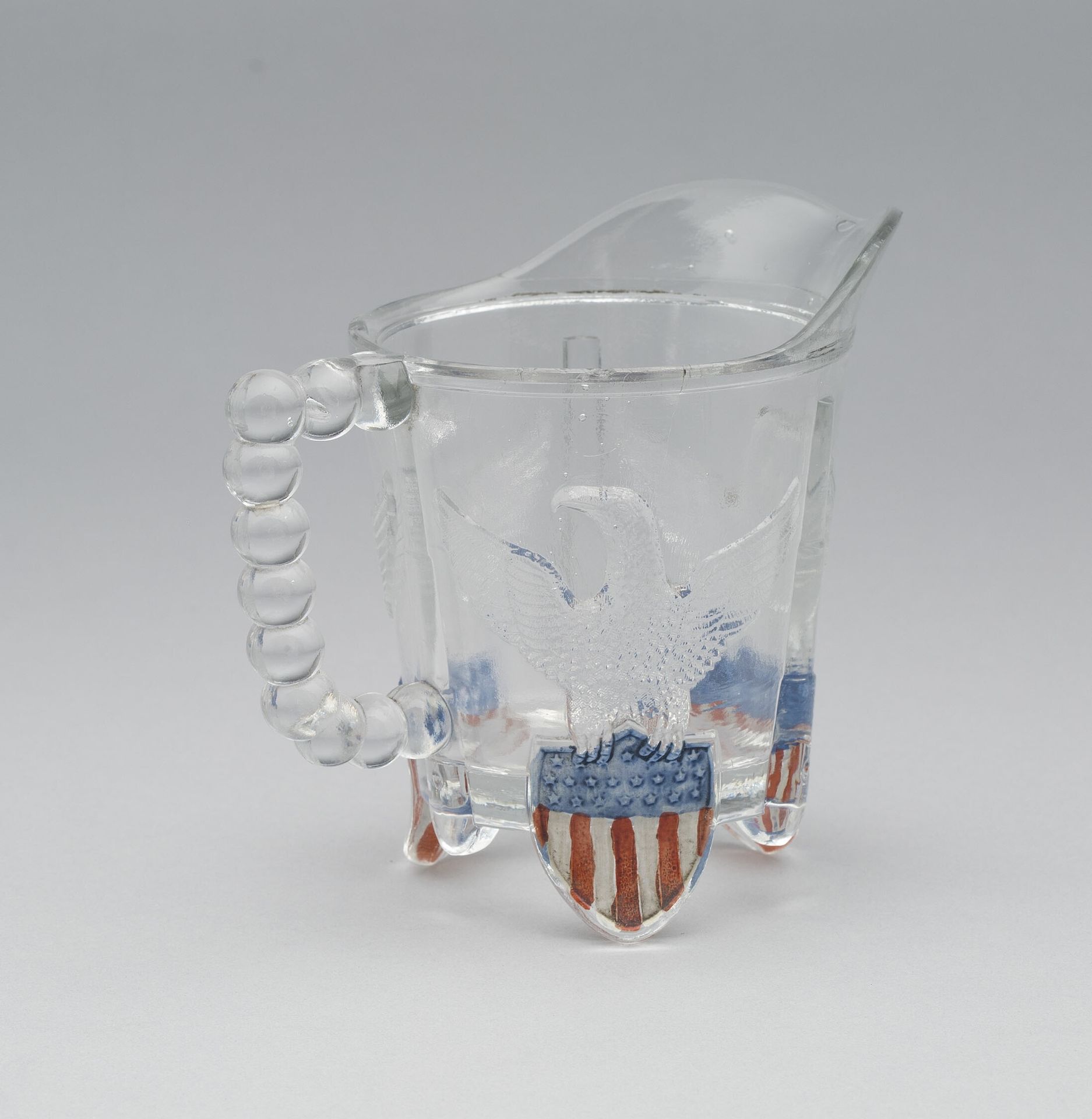 "Bullet & Emblem" pattern cream pitcher by Anonymous