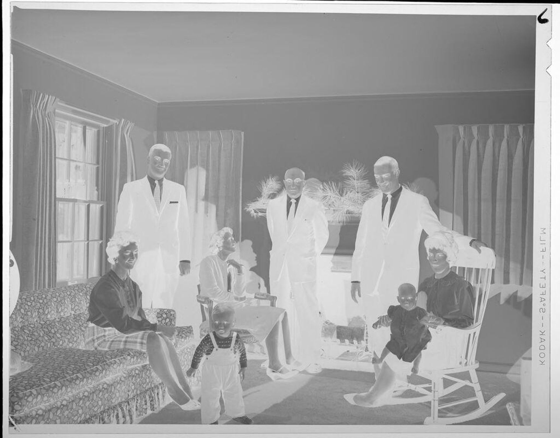 Untitled (men, women, and babies in living room) by Lucian and Mary Brown