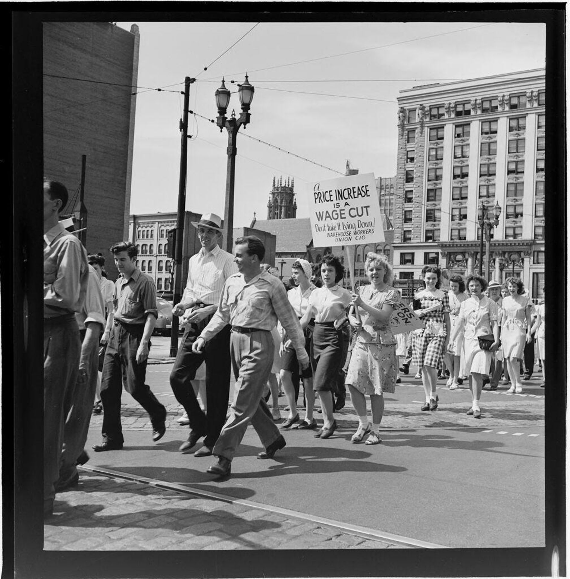Untitled (workers marching in strike on city street) by Jack Gould