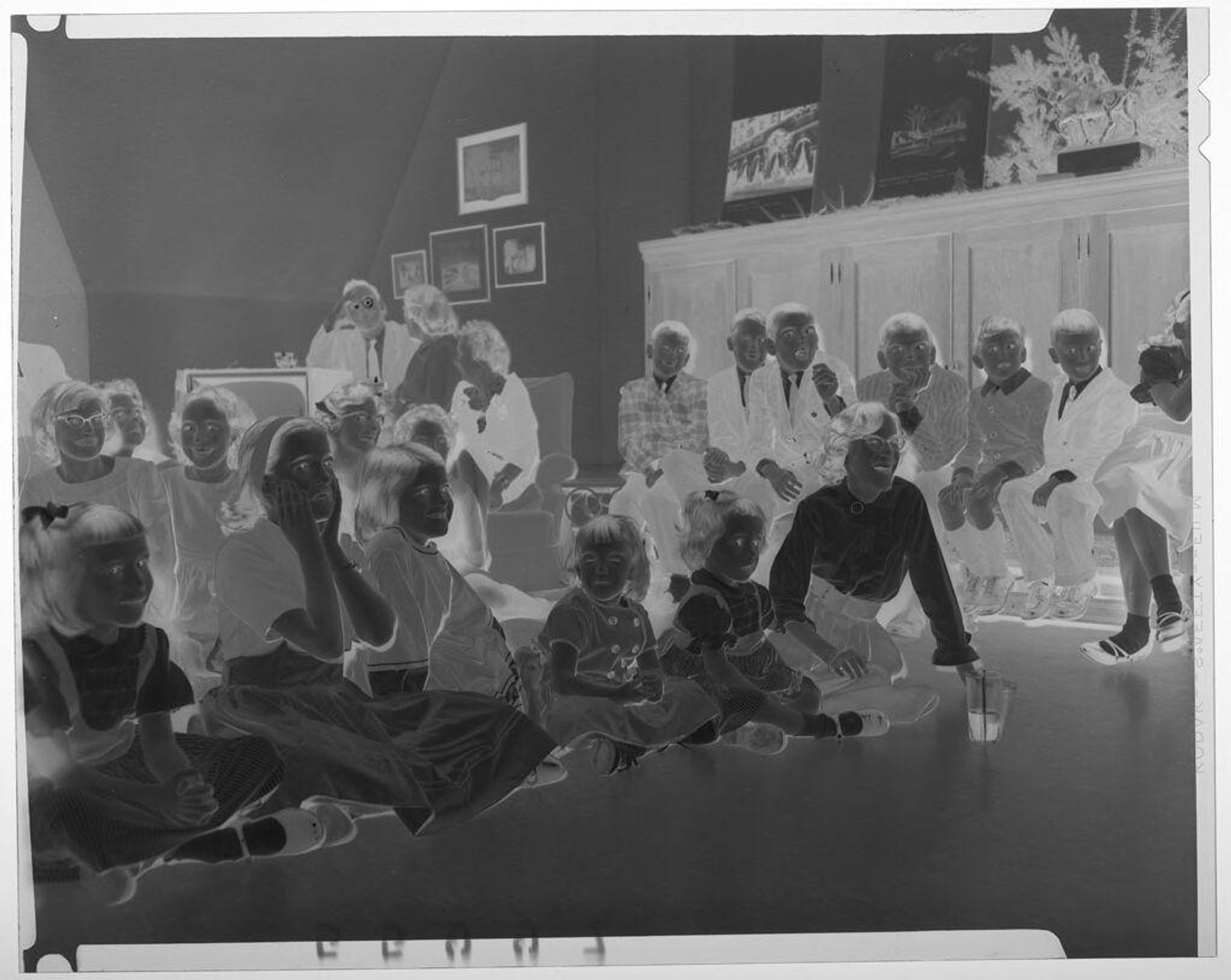 Untitled (large group of children watching performance during Christmas party) by Martin Schweig