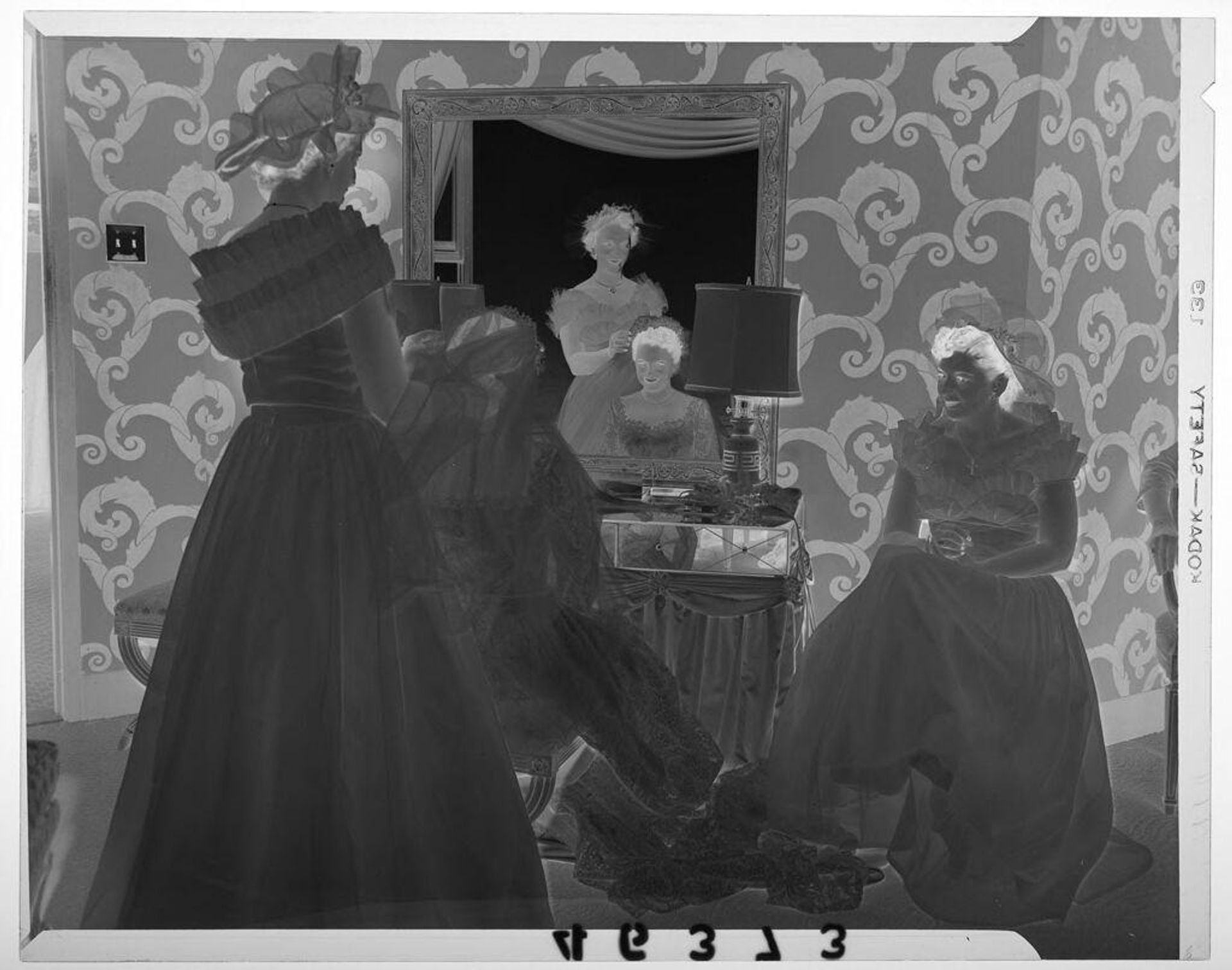 Untitled (woman adjusting bride's veil in mirror as friend watches) by Martin Schweig