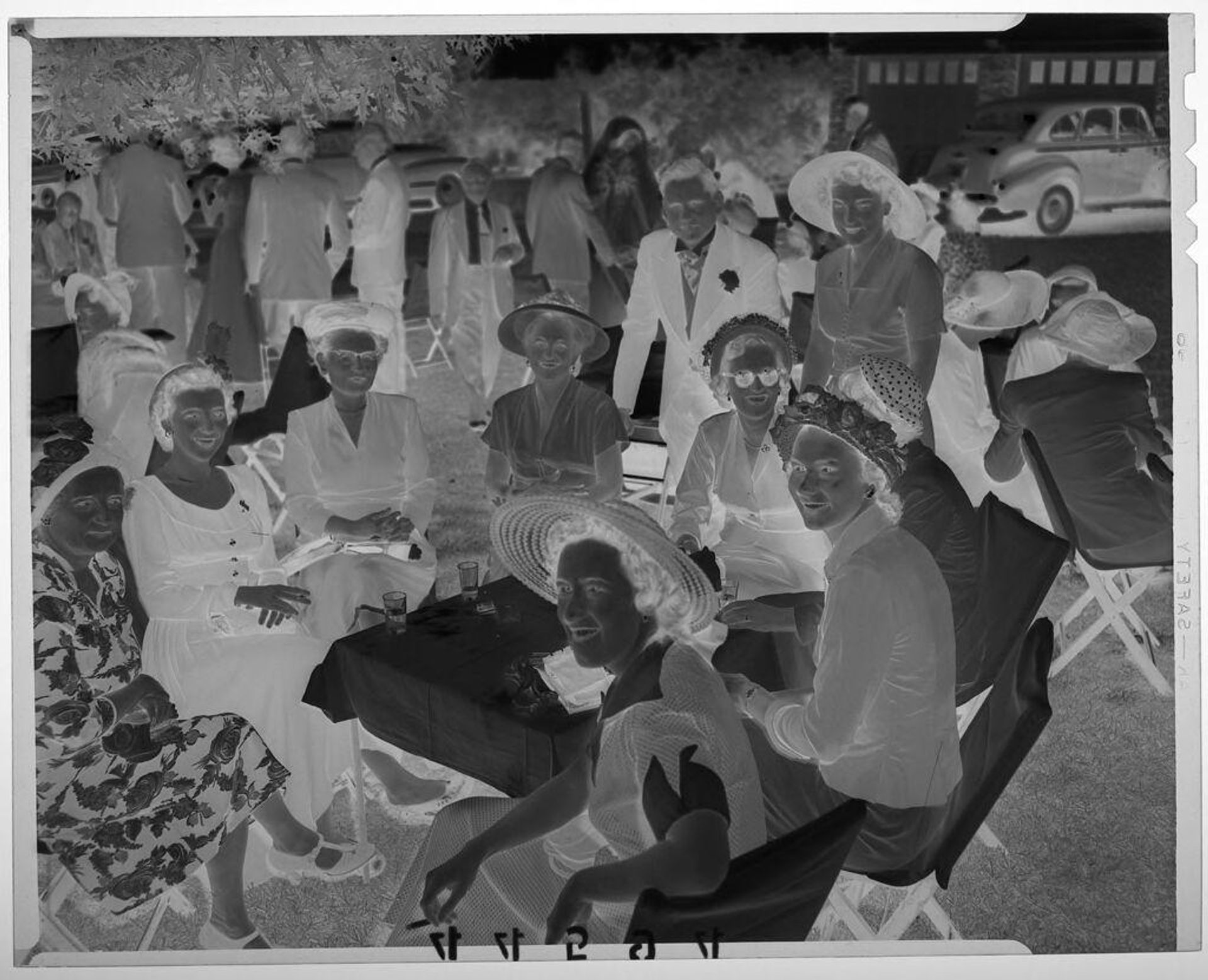 Untitled (women posed around table outdoors at wedding event) by Martin Schweig