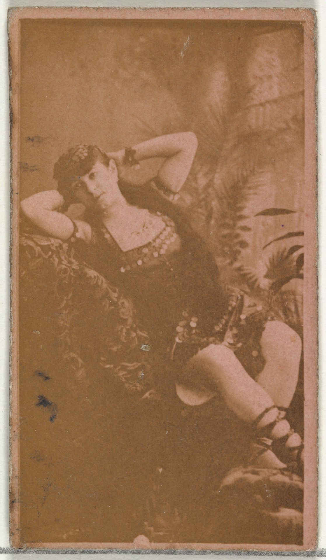 [Reclining actress with hands behind head], from the Actors and Actresses series (N145-8) issued by Duke Sons & Co. to promote Duke Cigarettes by W. Duke, Sons & Co.