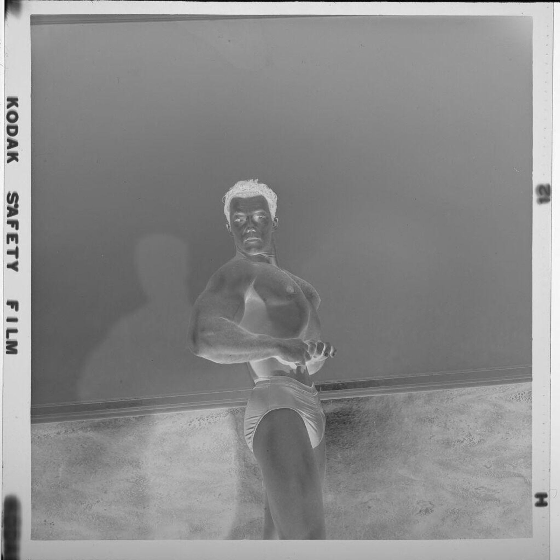 Untitled (man flexing muscles in "Mr. Universe" competition) by Jack Gould
