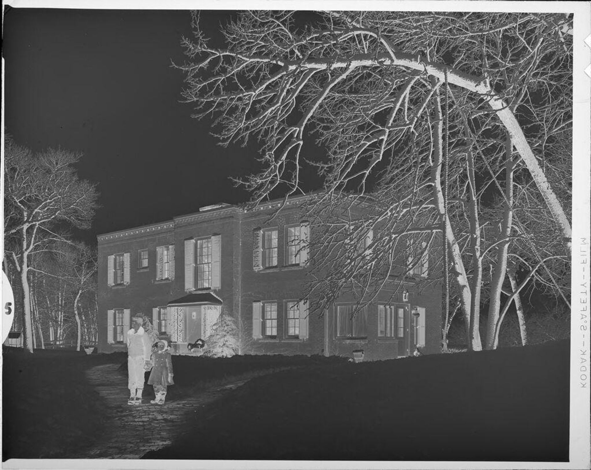Untitled (children in front of house in snow) by Lucian and Mary Brown