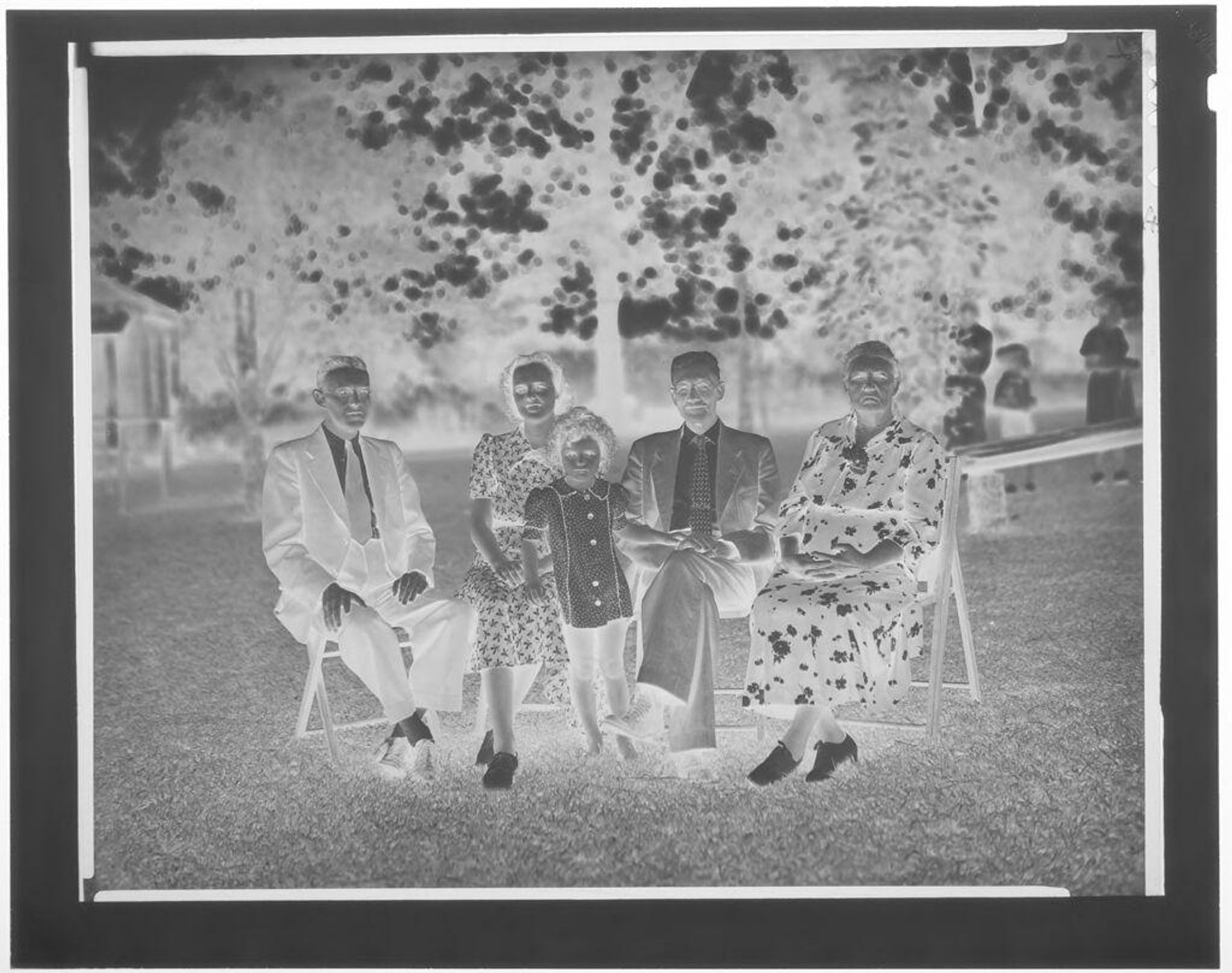Untitled (child, parents, and grandparents seated in yard) by Hamblin Studio