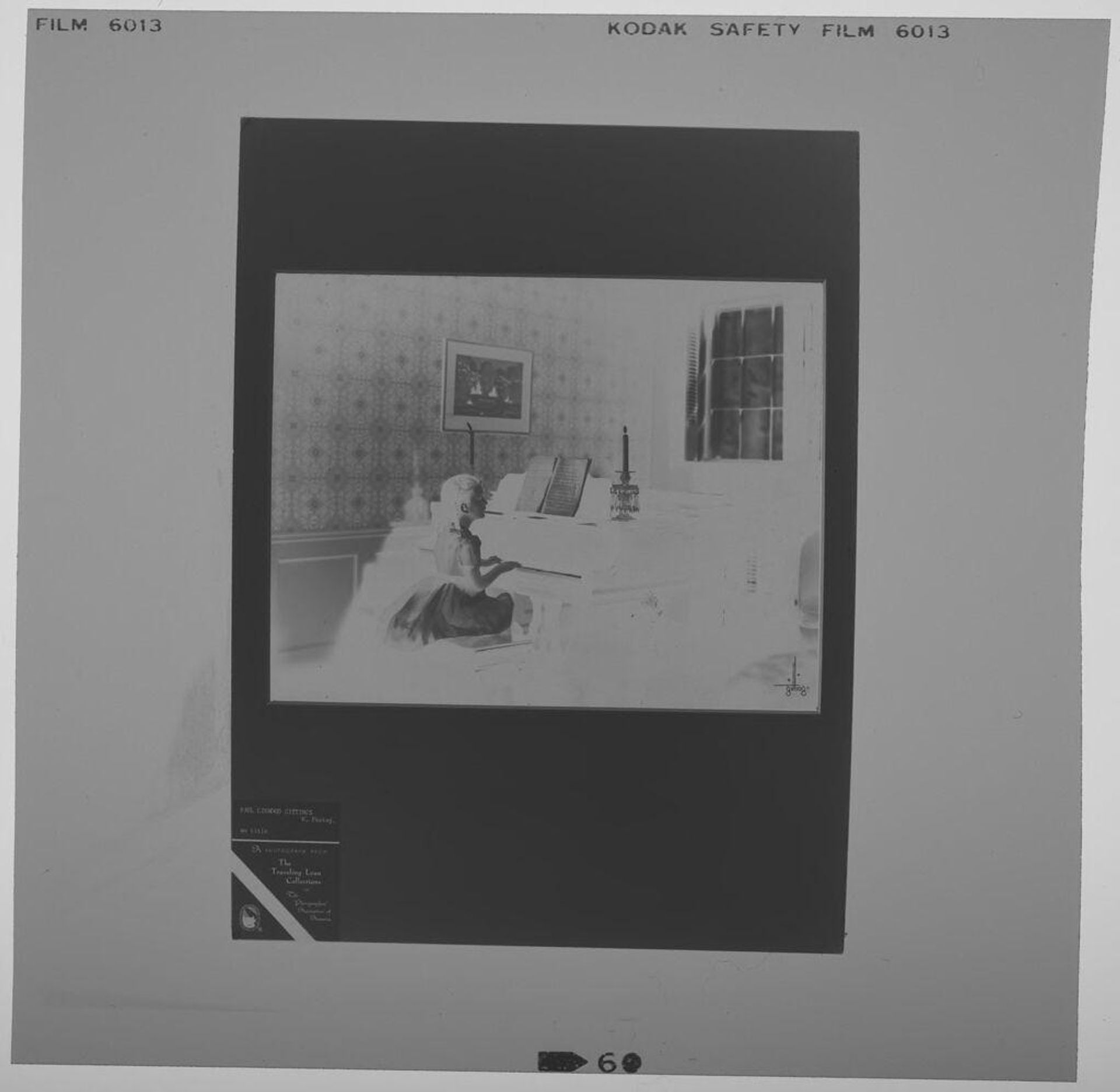 Untitled (photograph of girl playing piano) by Paul Gittings
