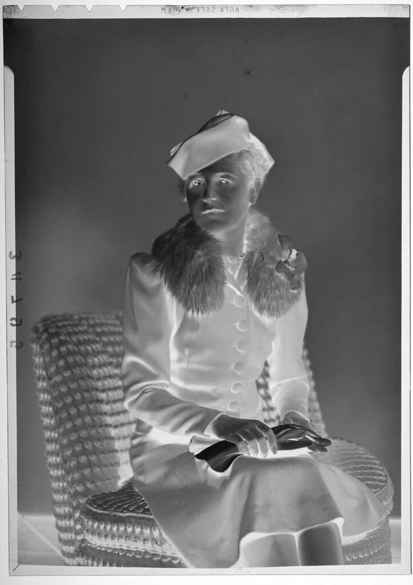 Untitled (studio portrait of woman wearing hat and coat with fur collar) by Martin Schweig