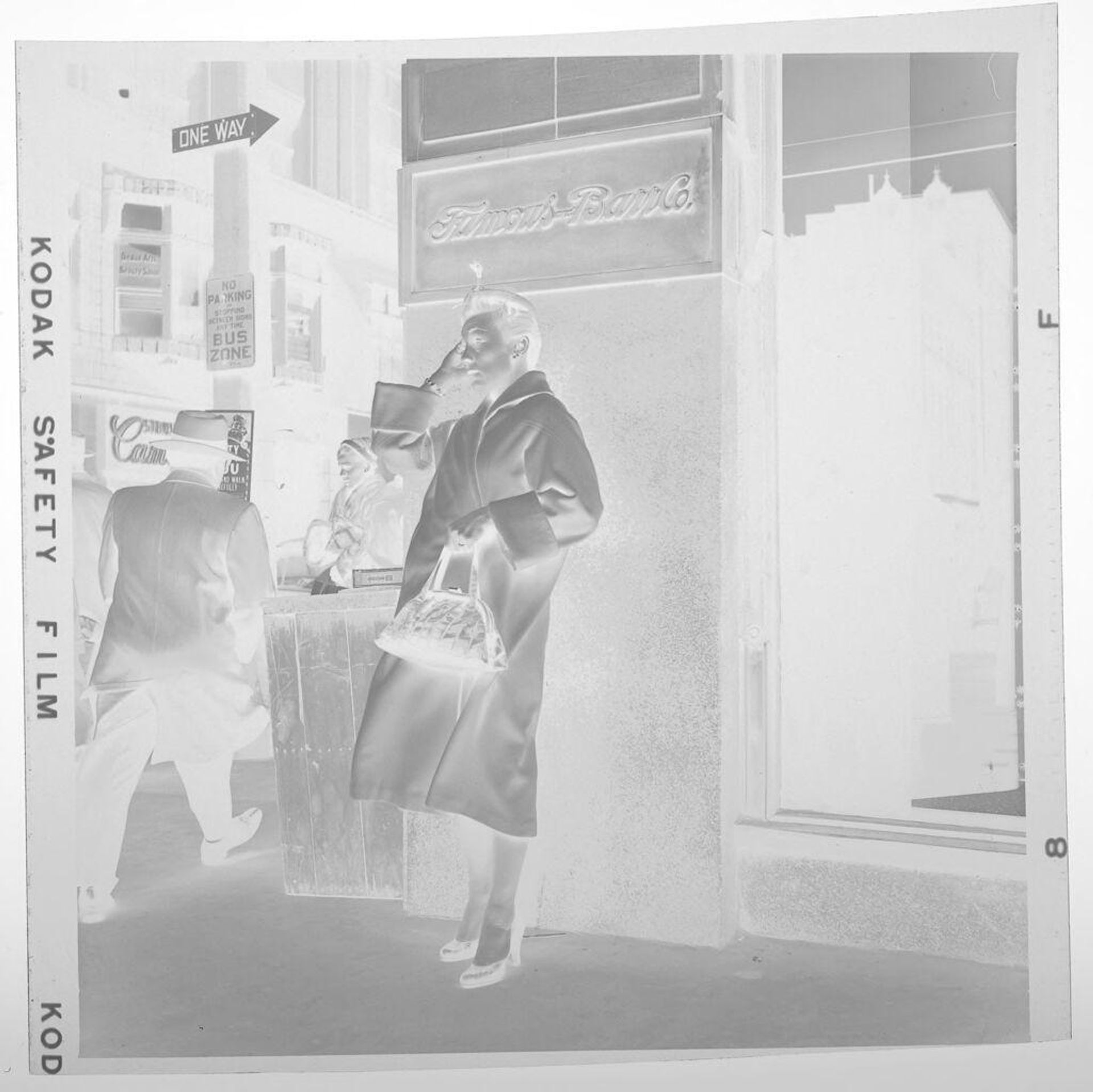 Untitled (woman with purse and coat standing outside in the wind) by Jack Gould