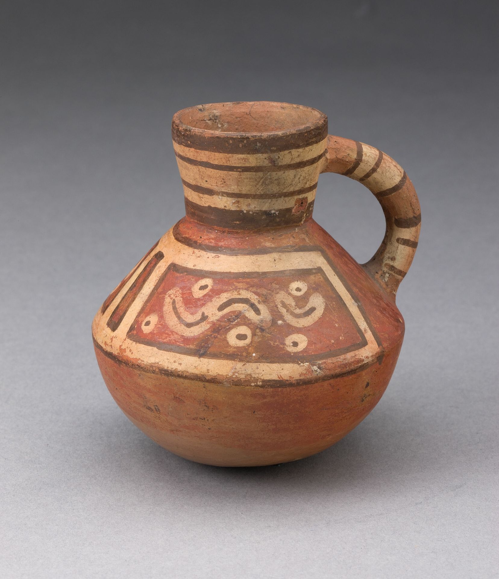 Miniature Handled Bottle with Abstract Motifs by Tiwanaku