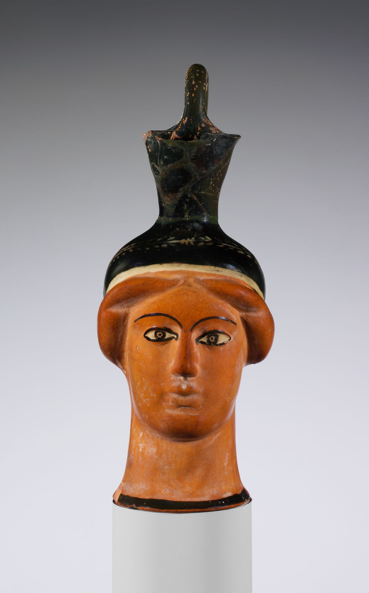 Terracotta oinochoe (jug) in the form of a woman's head by Class S: The Canessa Class of Head Vases