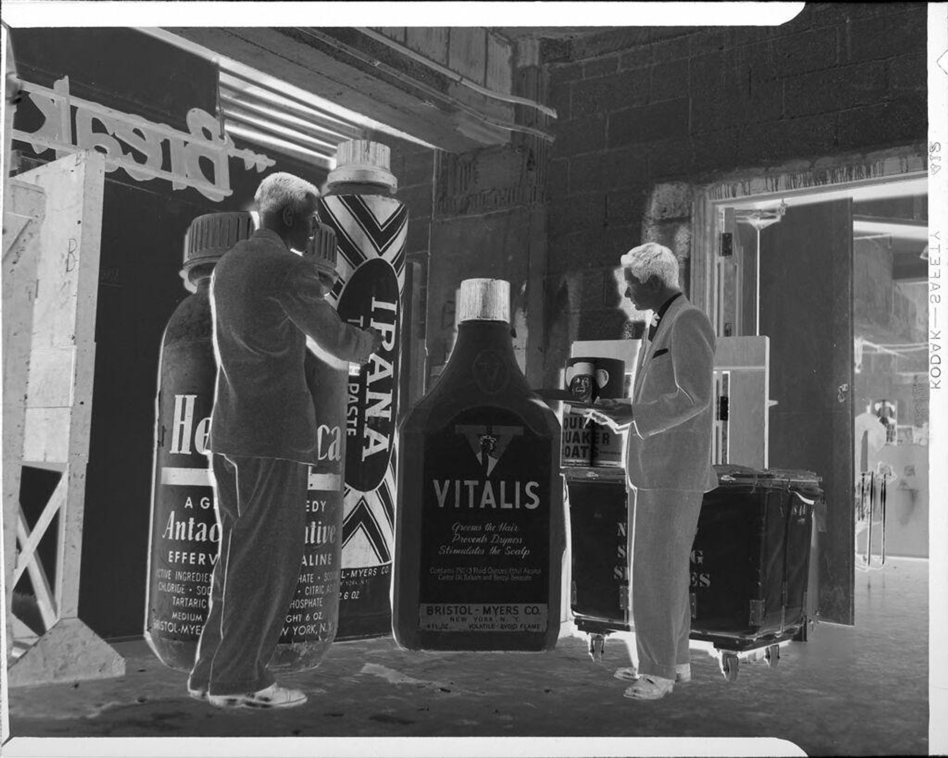 Untitled (men with large bottles for advertising) by Jean Raeburn