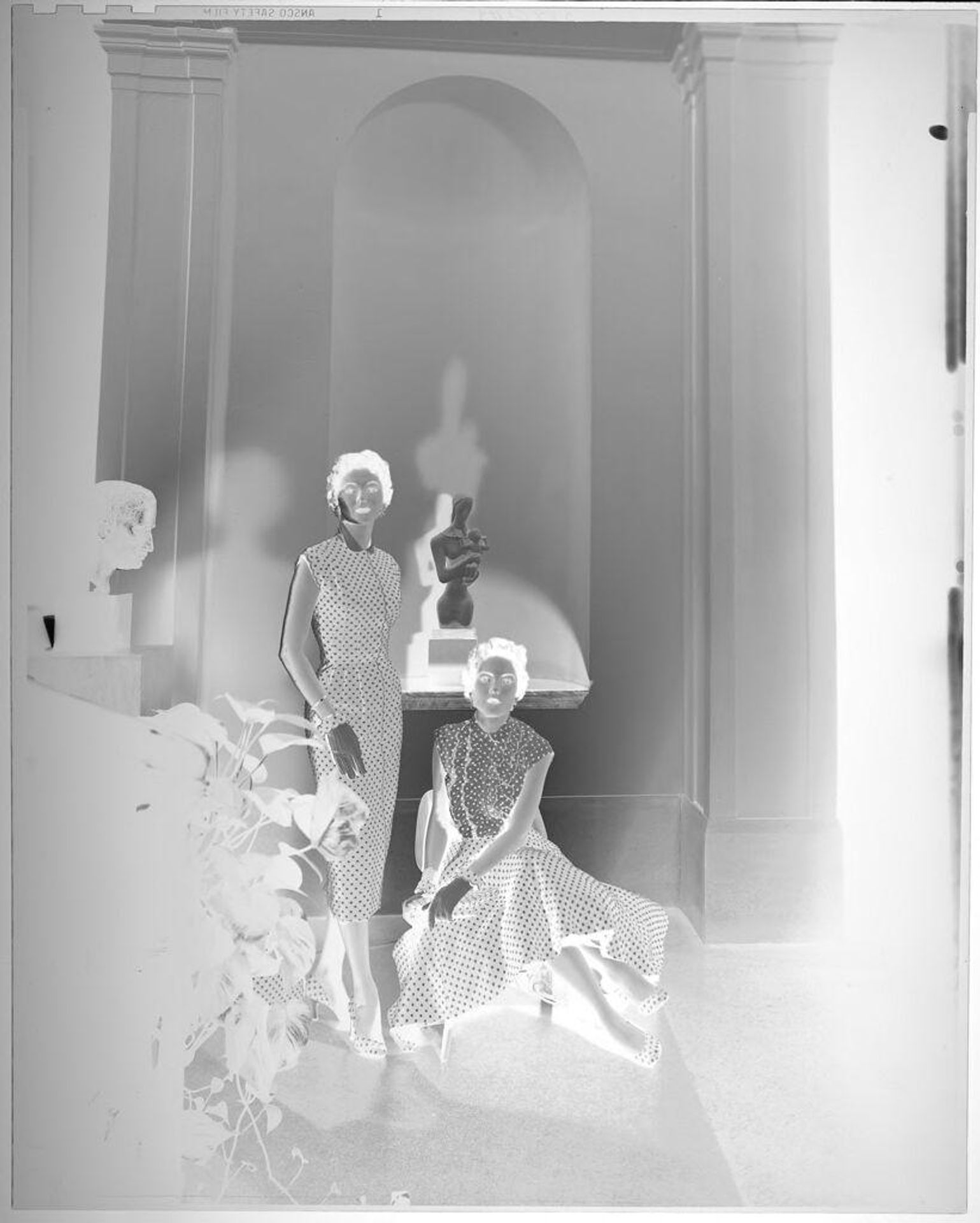 Untitled (two women in polka dot dresses pose inside Museum of Fine Arts, Houston, in front of statue) by Paul Gittings
