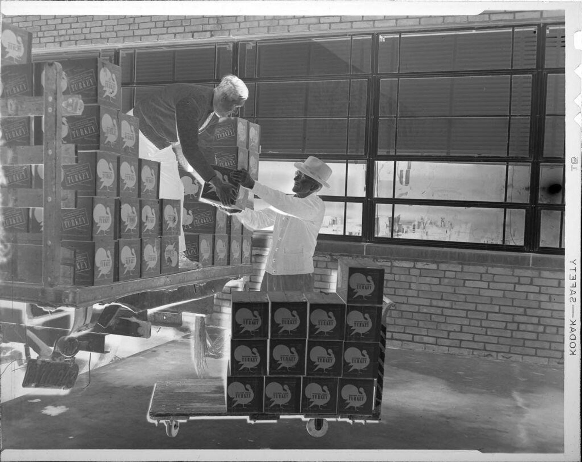 Untitled (men unloading boxed turkeys from truck) by Robert Burian