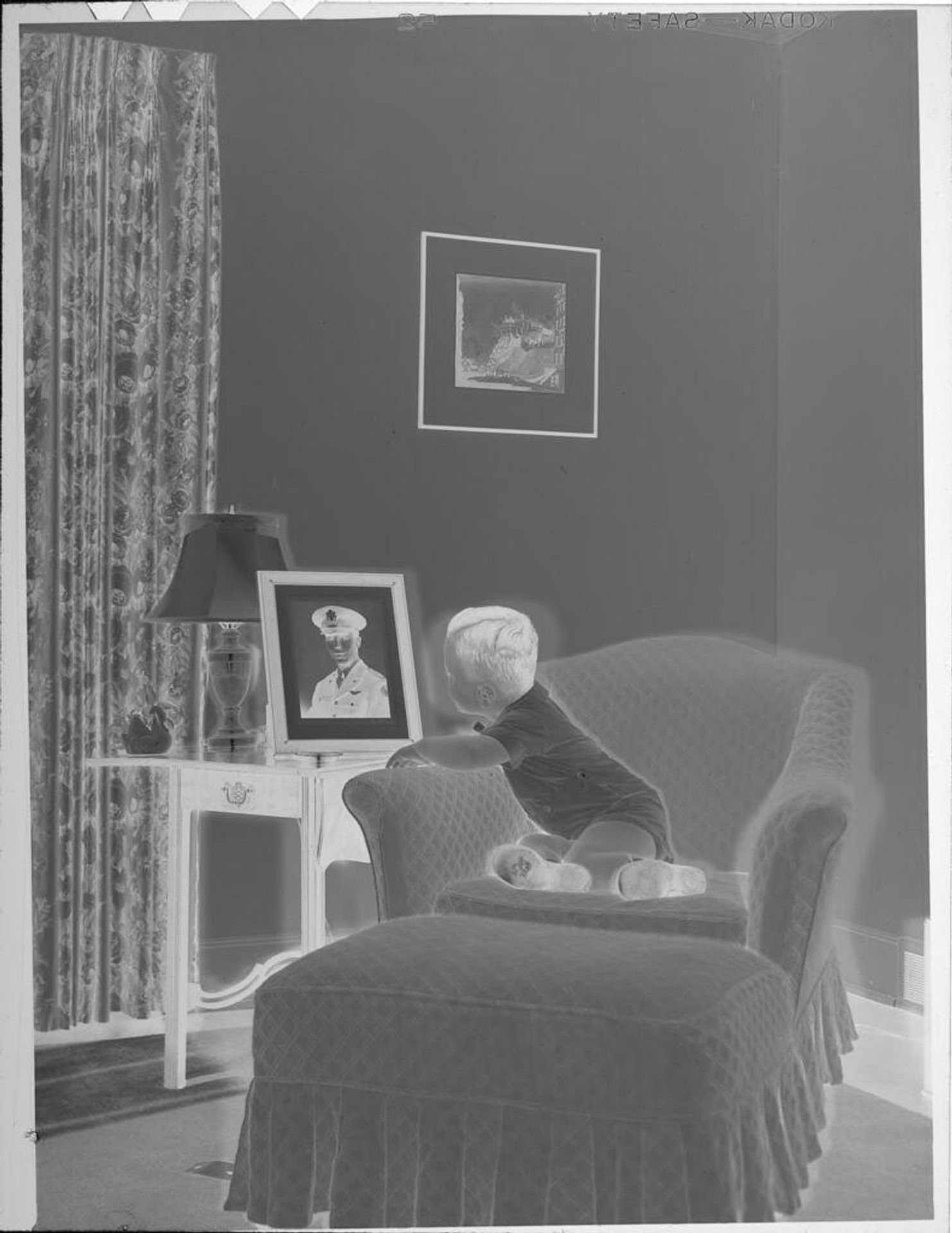 Untitled (baby looking at photograph of officer) by Lucian and Mary Brown