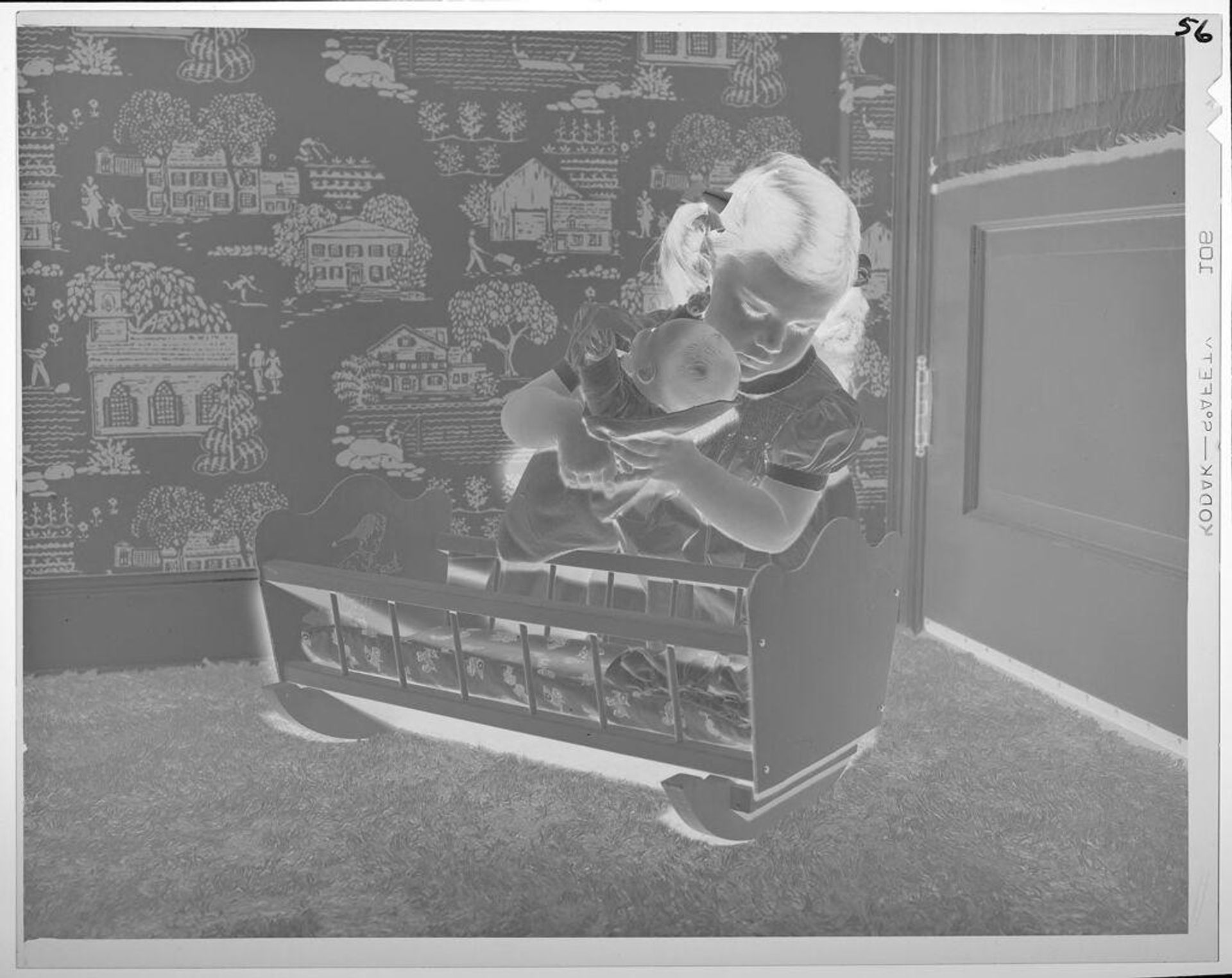 Untitled (girl putting doll into cradle) by Lucian and Mary Brown
