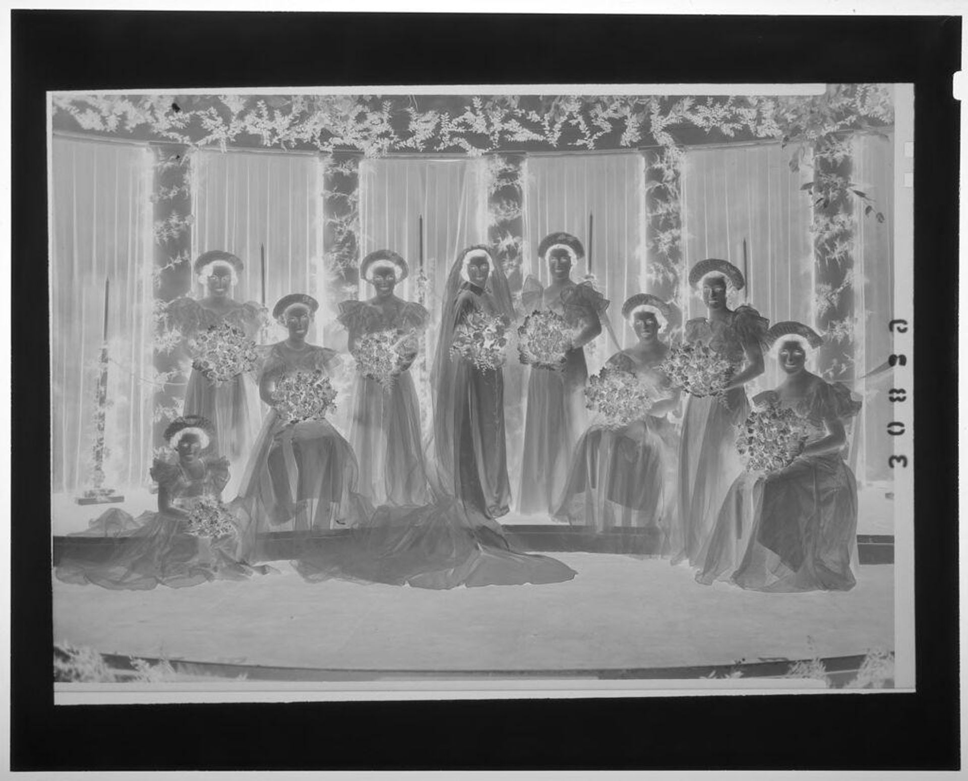 Untitled (group portrait of bride with seven bridesmaids in fanned hats in front of columns) by Martin Schweig