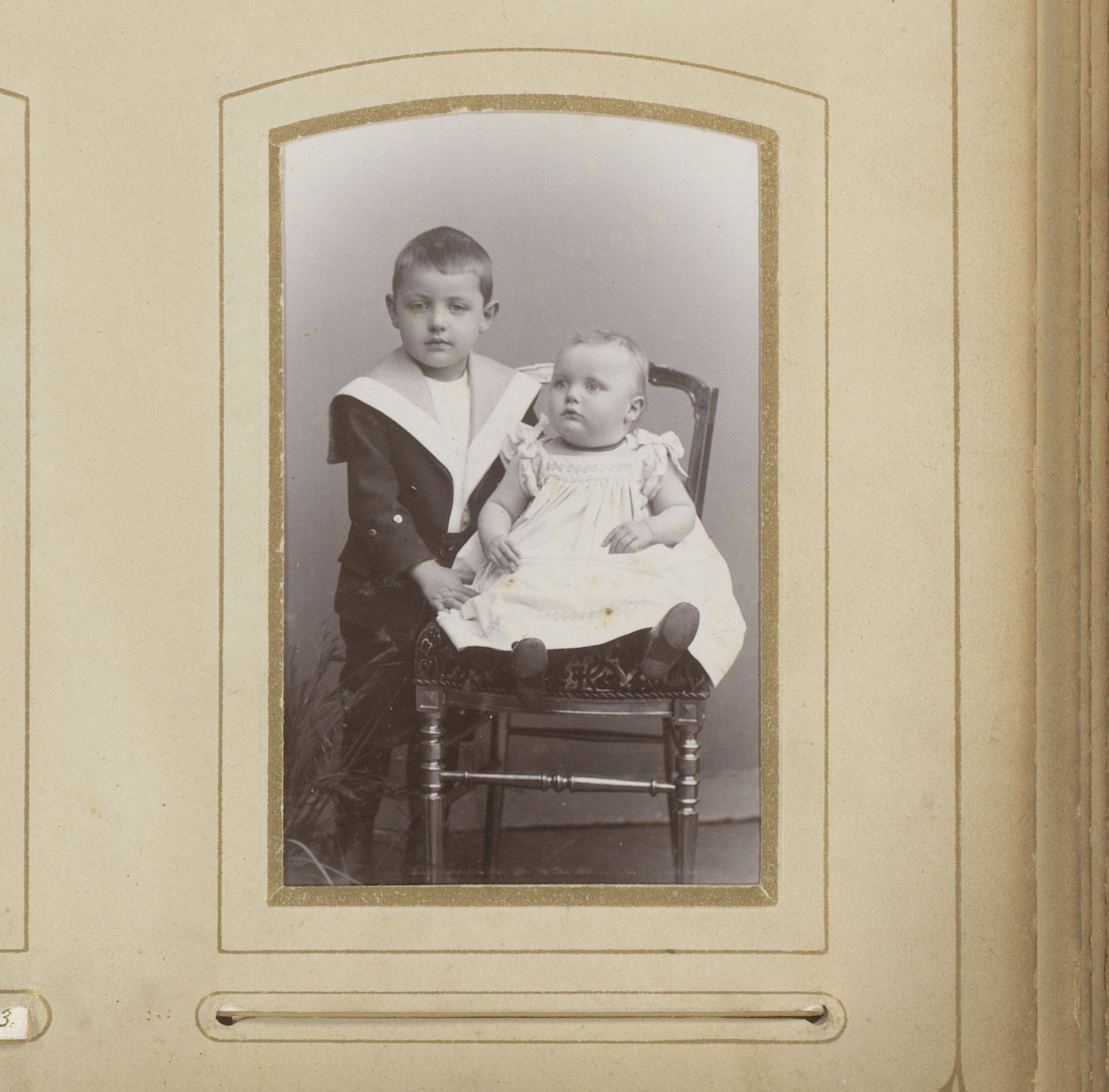 Portret van een jongen met een zittende baby op een stoel by Adolf Neumann