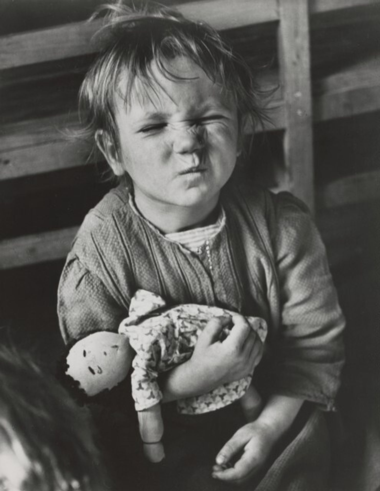 A child from the Sudeten region of Czechoslovakia plays with a homemade doll, Vienna, Austria by David Seymour